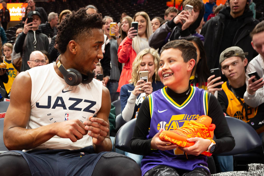 (Trent Nelson | The Salt Lake Tribune) Utah Jazz guard Donovan Mitchell (45) hands an autographed shoe to young fan Brigham Israelsen as the Utah Jazz prepare to host the San Antonio Spurs, NBA basketball in Salt Lake City on Saturday Feb. 9, 2019.