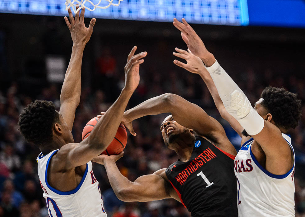 (Trent Nelson | The Salt Lake Tribune) Northeastern Huskies guard Shawn Occeus (1) defended by Kansas Jayhawks guard Ochai Agbaji (30) and Kansas Jayhawks forward Dedric Lawson (1) as Kansas faces Northeastern in the 2019 NCAA Tournament in Salt Lake City on Thursday March 21, 2019.