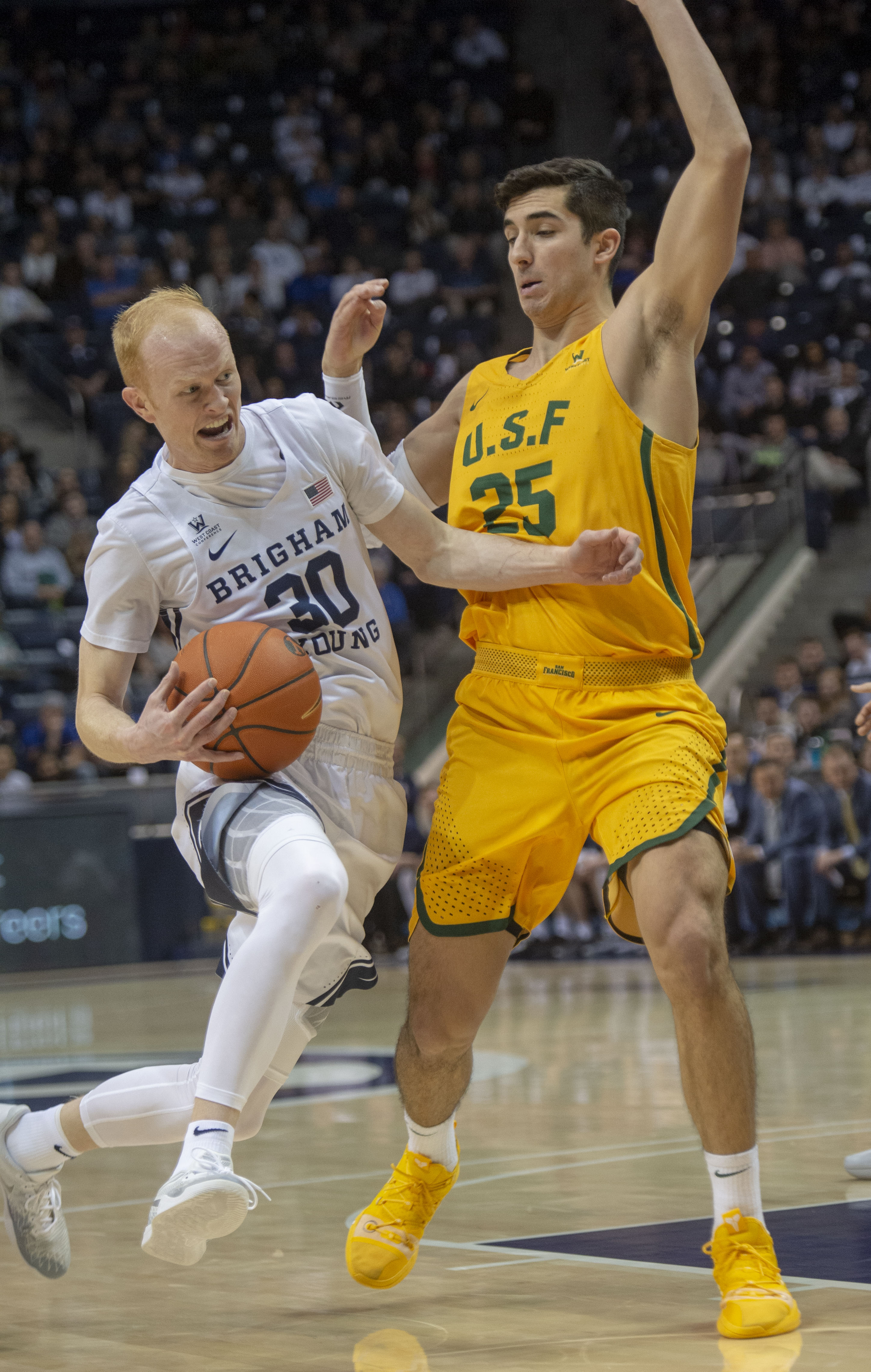 (Rick Egan | The Salt Lake Tribune) Brigham Young Cougars guard TJ Haws (30) takes the ball inside as San Francisco Dons guard Jordan Ratinho (25) defends, in WCC basketball action at the Marriott Center, Thursday, February 21, 2018. 