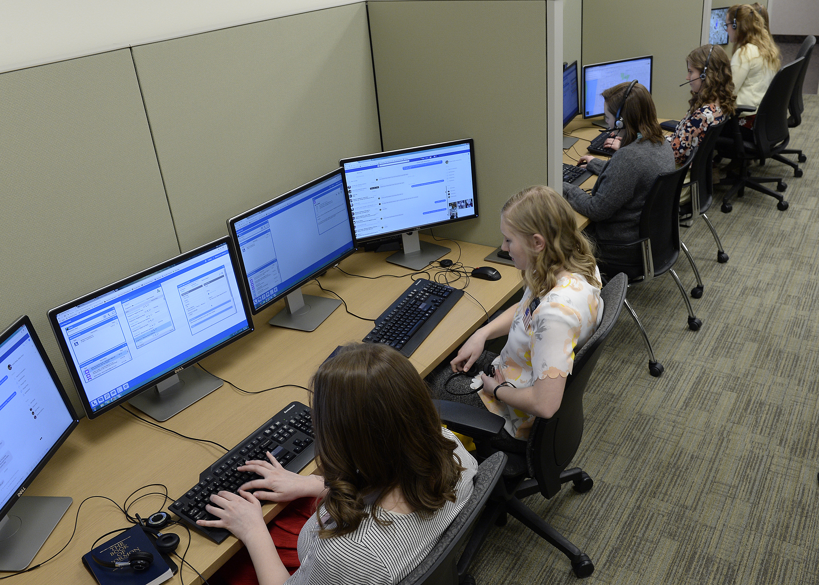 (Scott Sommerdorf | The Salt Lake Tribune) Rows of female missionaries spoke to contacts from the Temple Square North Visitor's Center, Thursday, March 8, 2018.