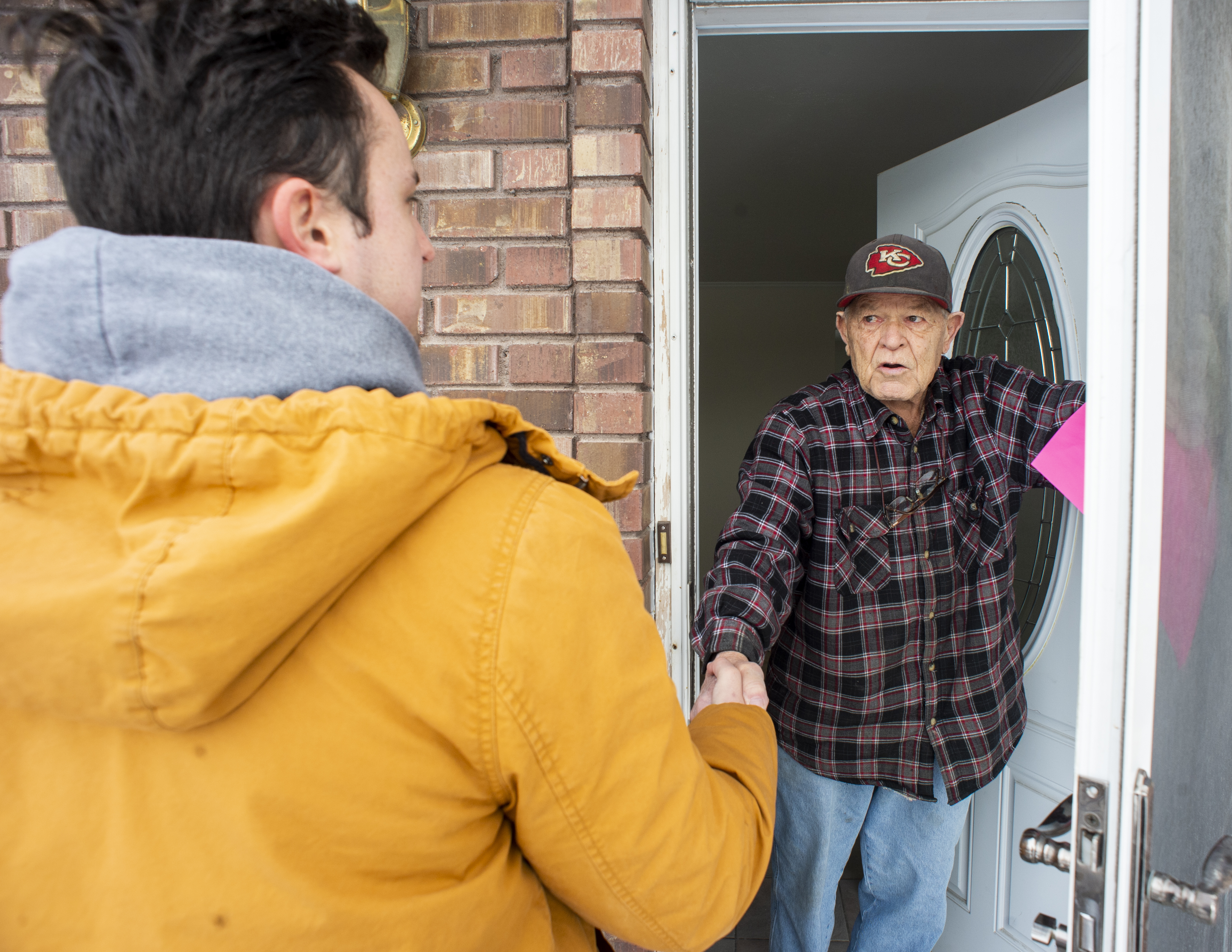 (Rick Egan | The Salt Lake Tribune) Keaton Hill talks to Ron Bishop, as he goes door to door in a neighborhood in Taylorsville with other supporters of the fuller Medicaid expansion, urging residents to call their senator, Saturday, Feb. 9, 2019. 