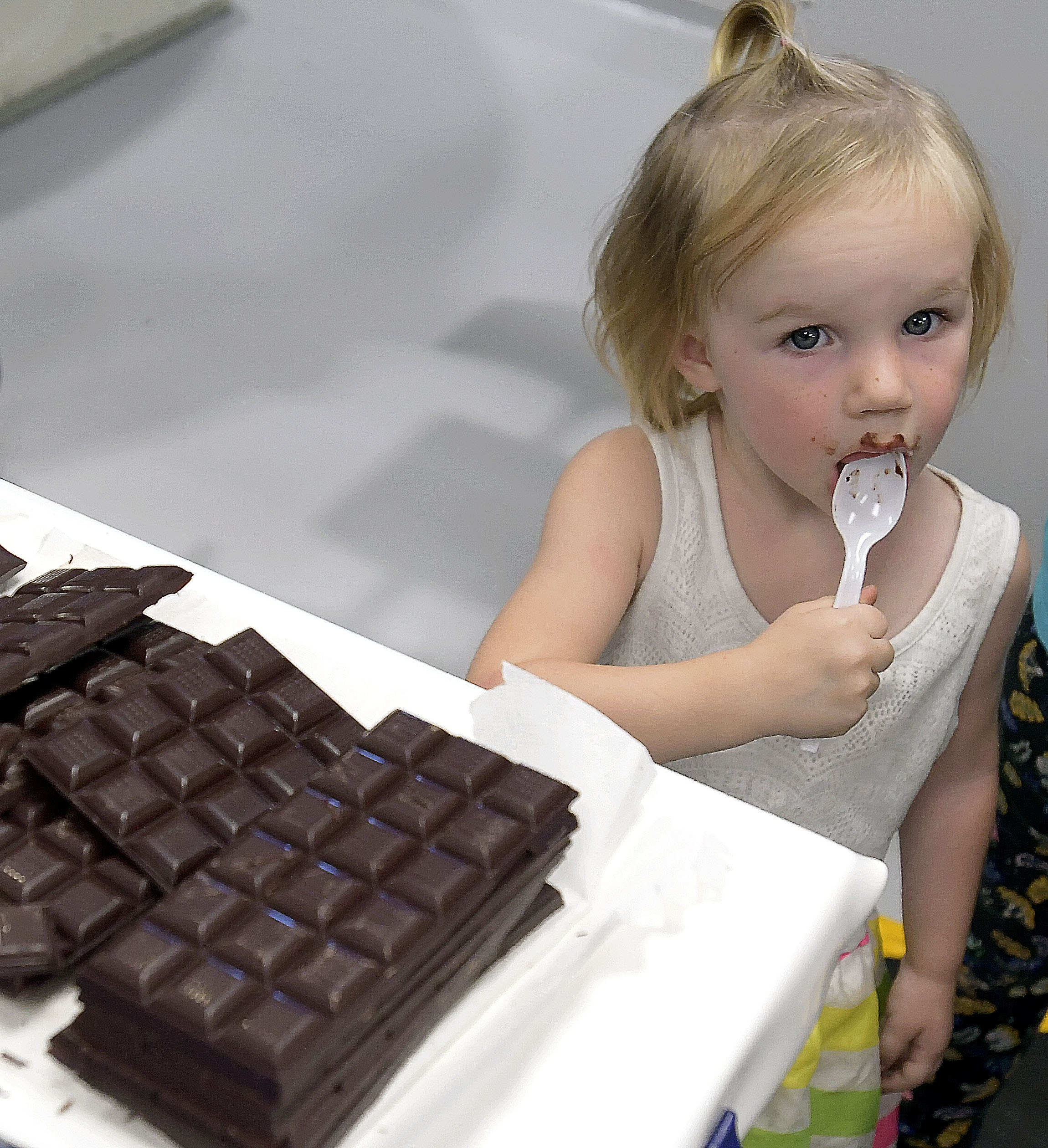 (Eli Lucero | The Herald Journal) Quinn Esplin has a taste of dark chocolate during a public tour of the Aggie Chocolate Factory on Tuesday in Logan.
