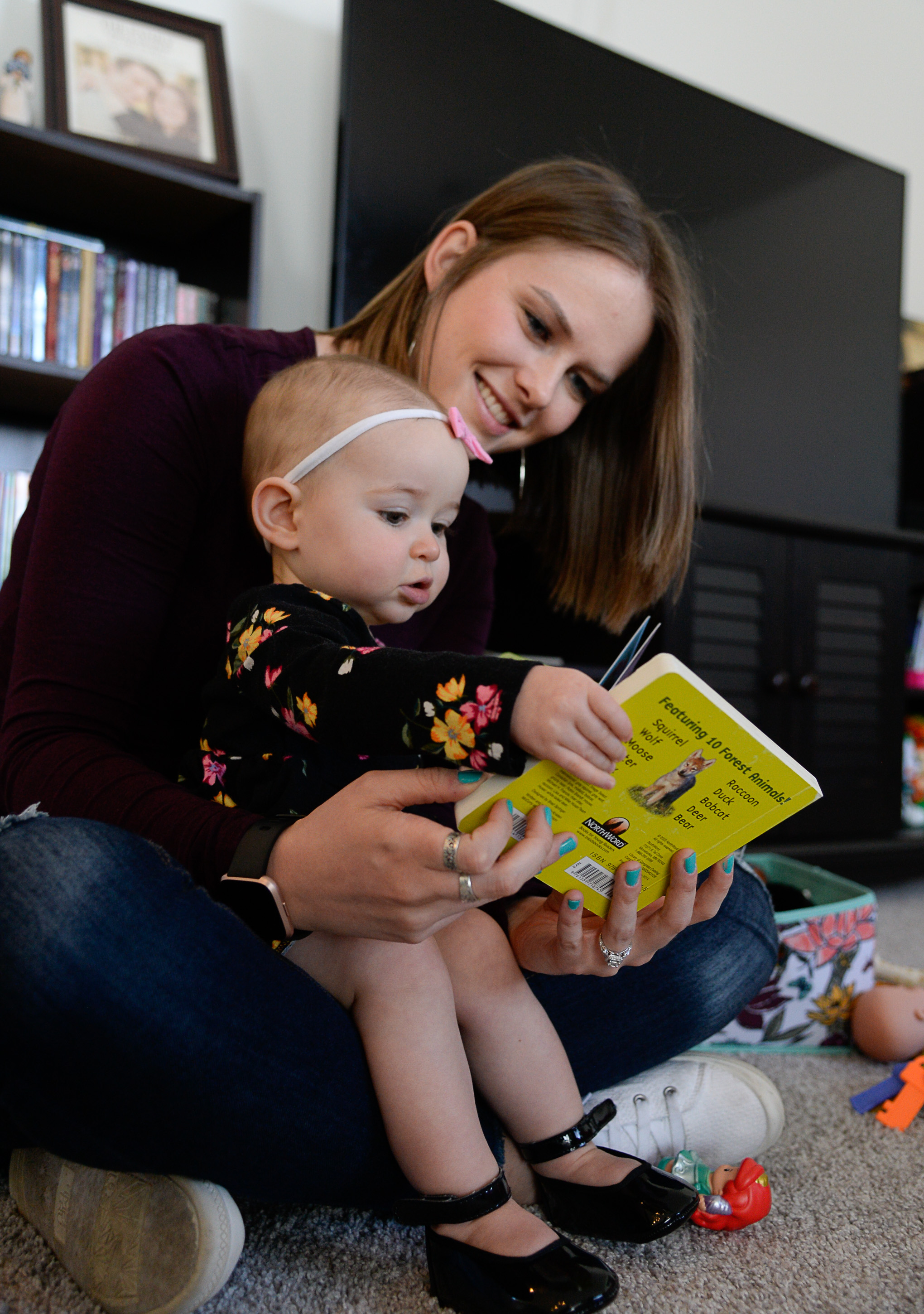 (Francisco Kjolseth | The Salt Lake Tribune) Ember Ulrich reads with her daughter Jemma, 1, at their home in Lehi after moving there last October. Ember and her husband Jeremy started looking for a place where they could get more home for their money along with some friends who ended up moving in next door in Lehi. Jeremy was also looking for a place closer to his job at Adobe in Lehi 