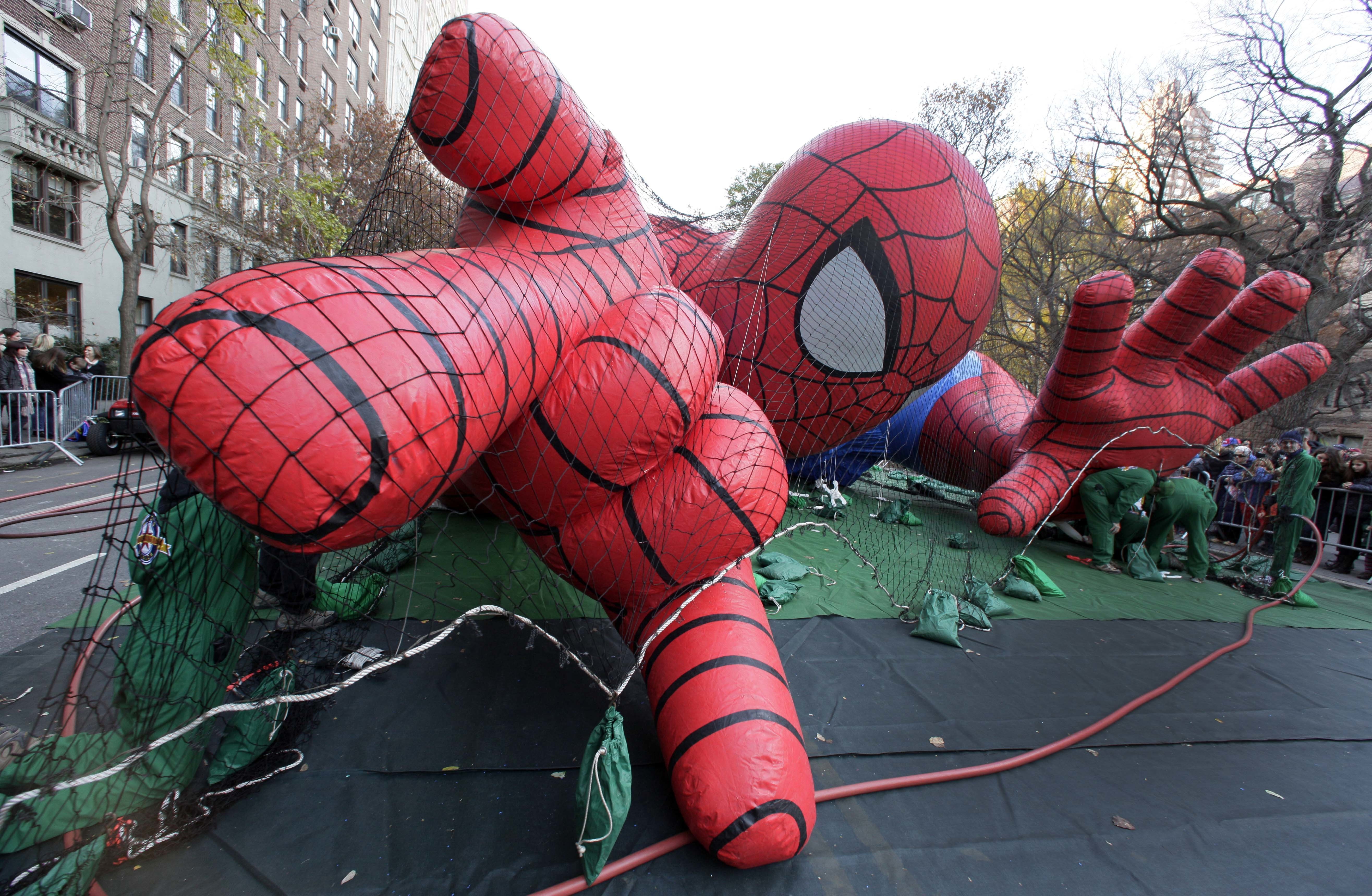 (AP Photo/Richard Drew, File) In this Nov. 21, 2012, photo, workers inflate the Spider-Man balloon for the annual Macy's Thanksgiving Day Parade in New York.