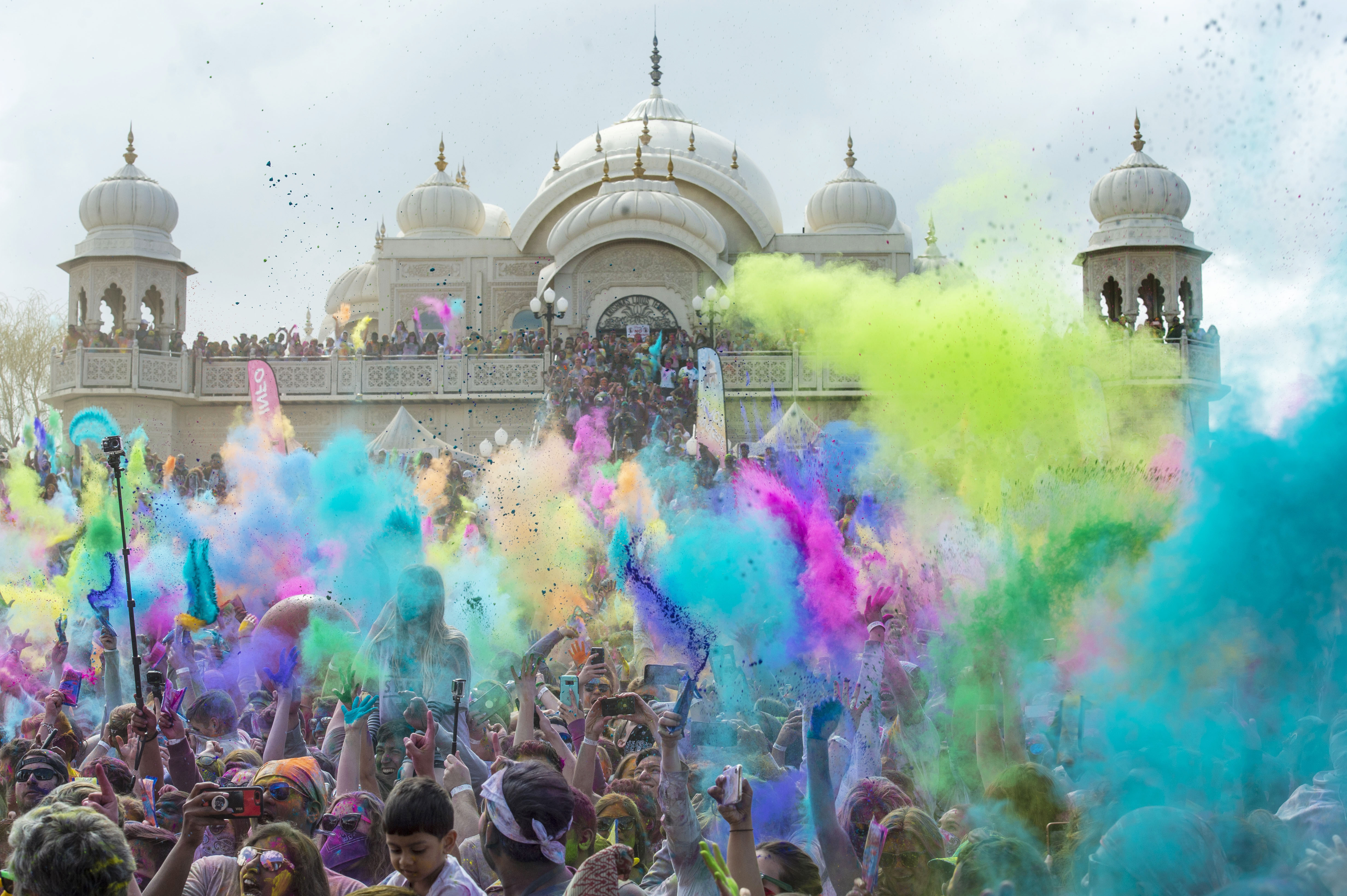 (Rick Egan | The Salt Lake Tribune) Revelers toss colored powder into the air as they celebrate the arrival of spring, during the Holi Festival of Colors celebration at the Sri Sri Radha Krishna Temple in Spanish Fork, Saturday, March 30, 2019. 