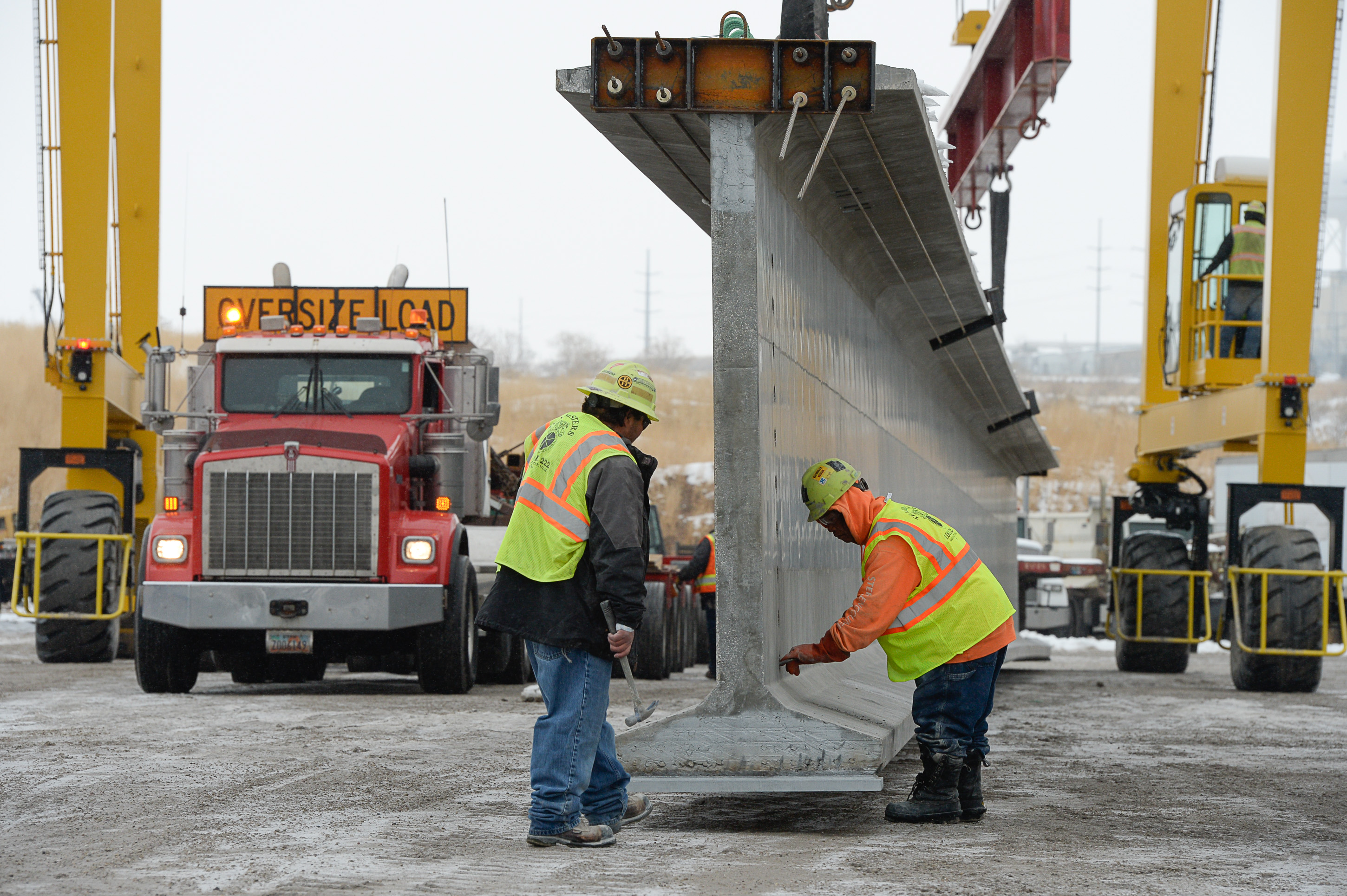 (Francisco Kjolseth | The Salt Lake Tribune) UDOT gets ready to place some of the world's largest-ever bridge beams, and the largest in Utah state history with a span of 203 ft long and just over 8 ft tall, as crews load one on a truck following manufacturing at Forterra Structural Precast in Kearns on Tuesday, Dec. 11, 2018. A total of six beams will be installed in the technology corridor in Lehi later this week.