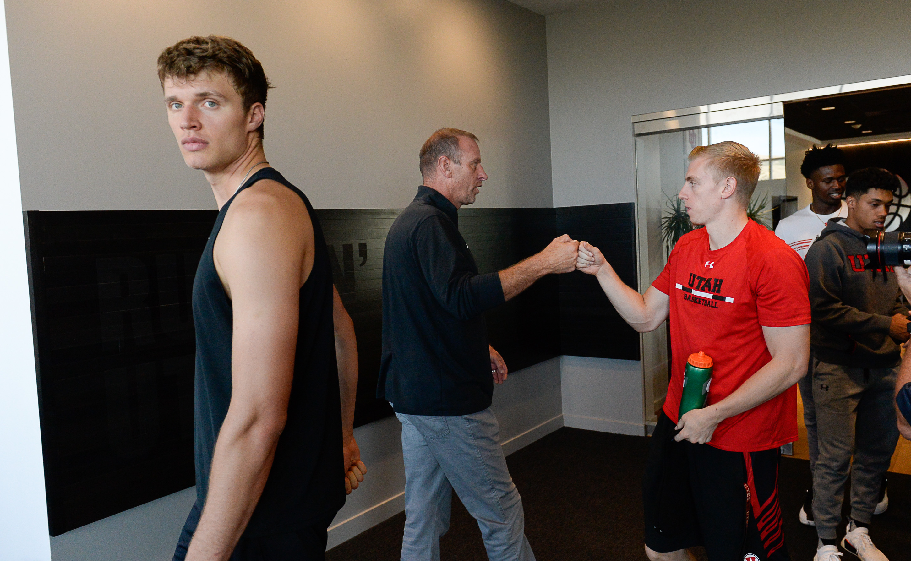 (Francisco Kjolseth | The Salt Lake Tribune) Utah basketball player Jayce Johnson, left, and Parker Van Dyke are greeted by Utah basketball coach Larry Krystkowiak, center, during media day at the Ute basketball practice facility on Wed. Sept. 26, 2018.