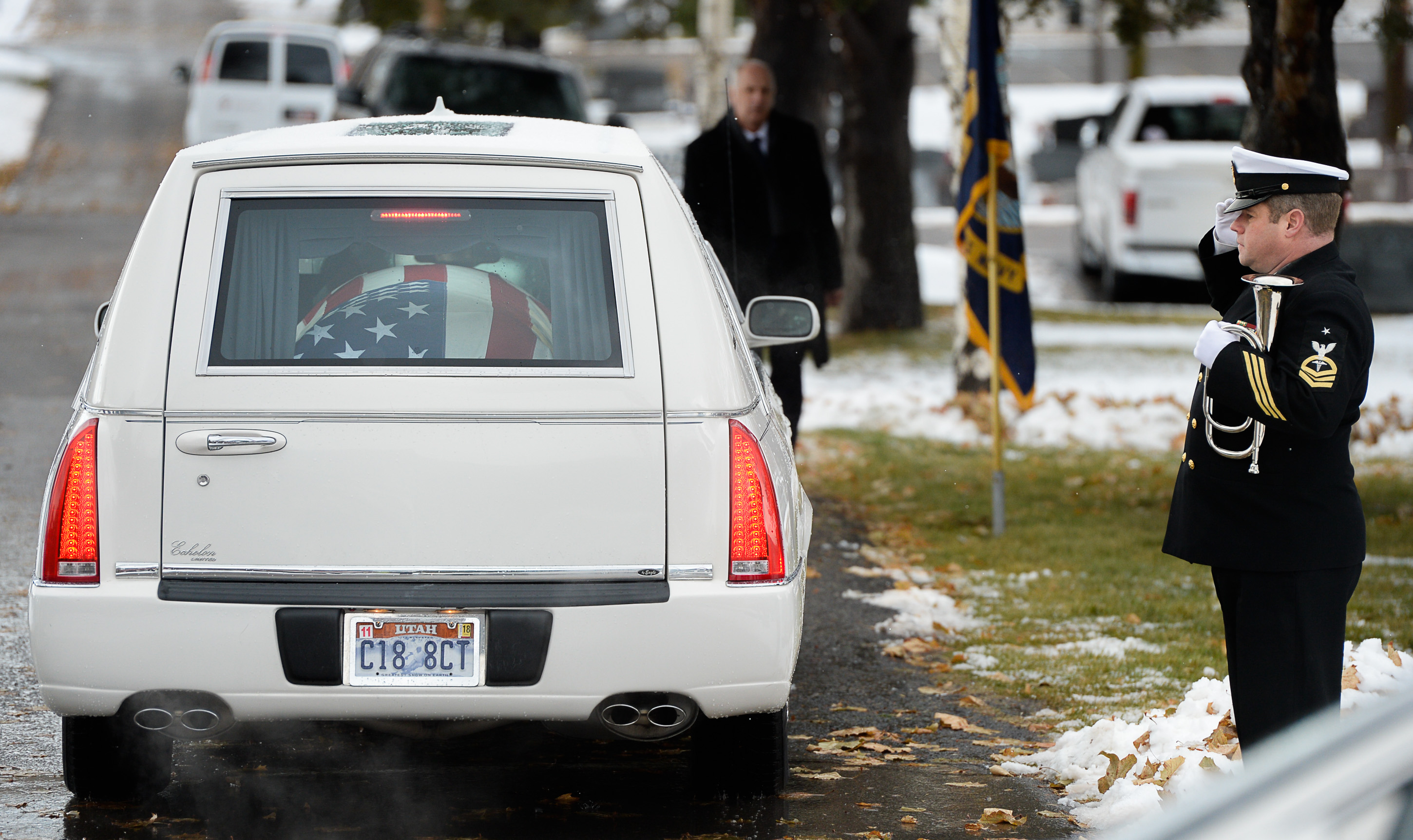 (Francisco Kjolseth | The Salt Lake Tribune) The flag-draped casket of former congressman Jim Hansen arrives at Farmington City Cemetery, Saturday, Nov. 24, 2018, as Sr. Chief Brian Frees salutes its arrival.