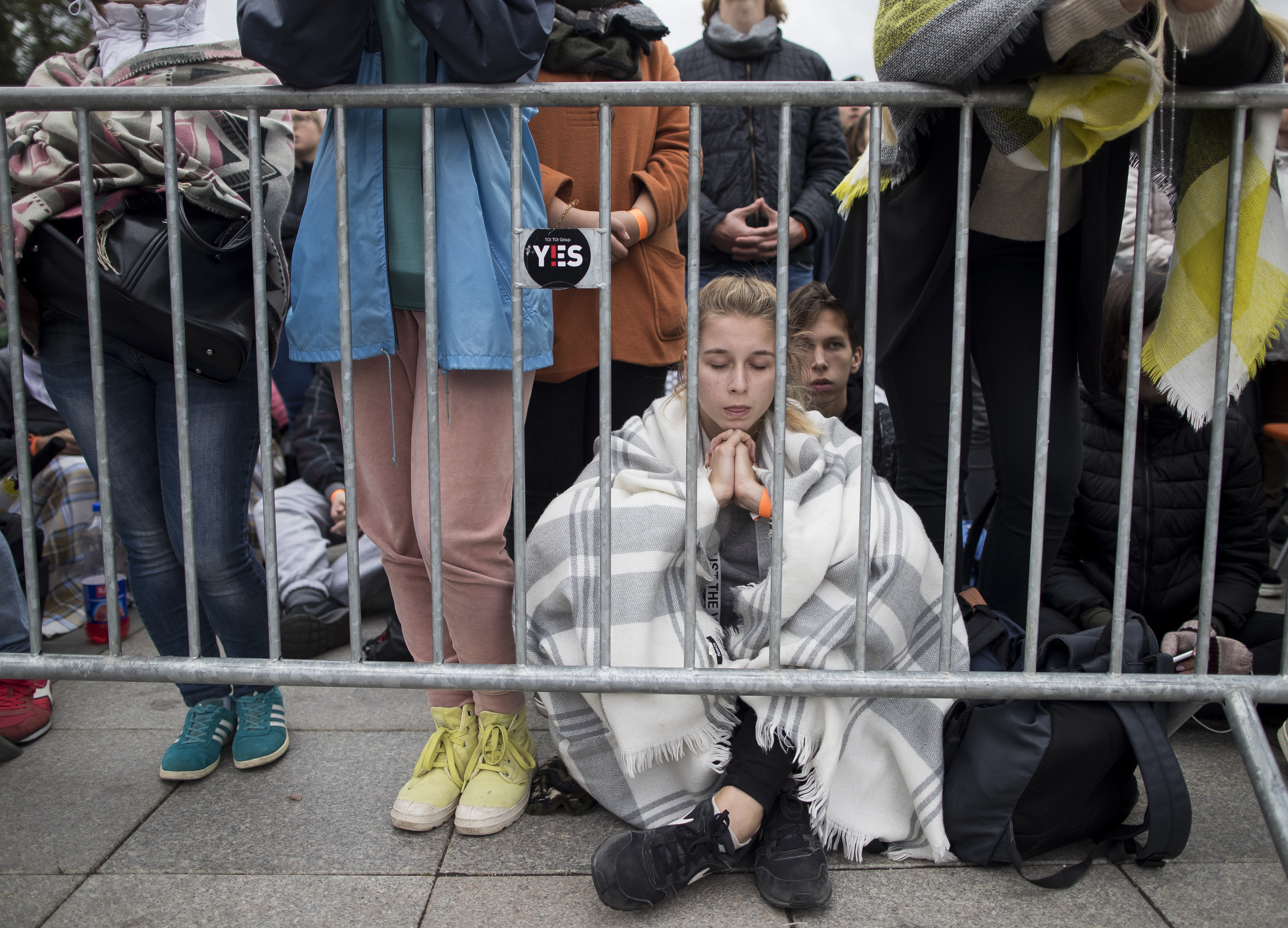 (Mindaugas Kulbis | AP Photo) A girl prays as faithful gather in Cathedral Square as they wait for the arrival of Pope Francis, in Vilnius, Lithuania, Saturday Sept. 22, 2018. Pope Francis begins a four-day visit to the Baltics amid renewed alarm about Moscow's intentions in the region it has twice occupied.