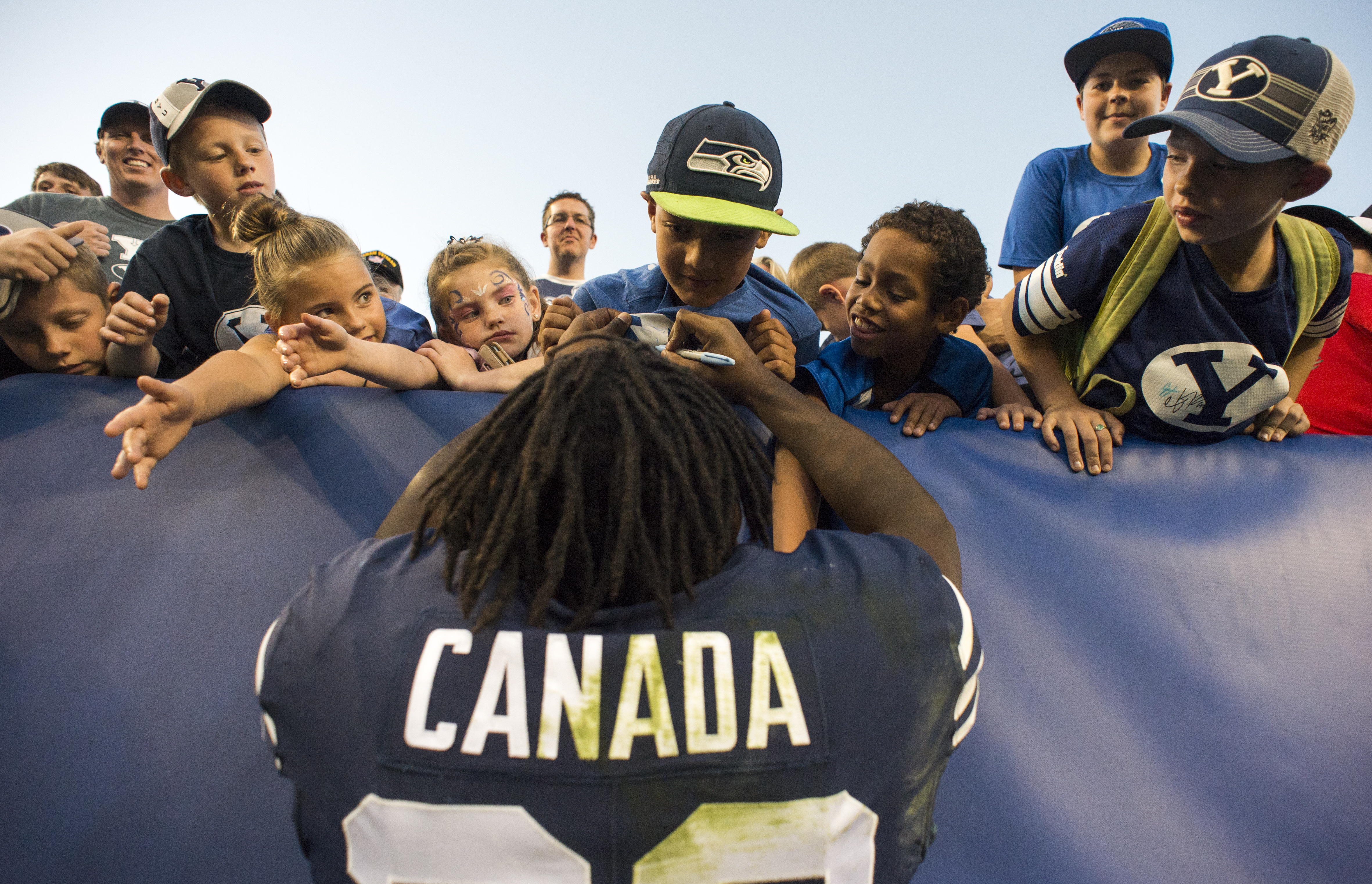 (Rick Egan | The Salt Lake Tribune) Brigham Young Cougars running back Squally Canada (22) signs autographs after the Brigham Young Cougars defeated the McNeese State Cowboys 30-3, at Lavell Edwards Stadium, Saturday, Sept. 22, 2018. 