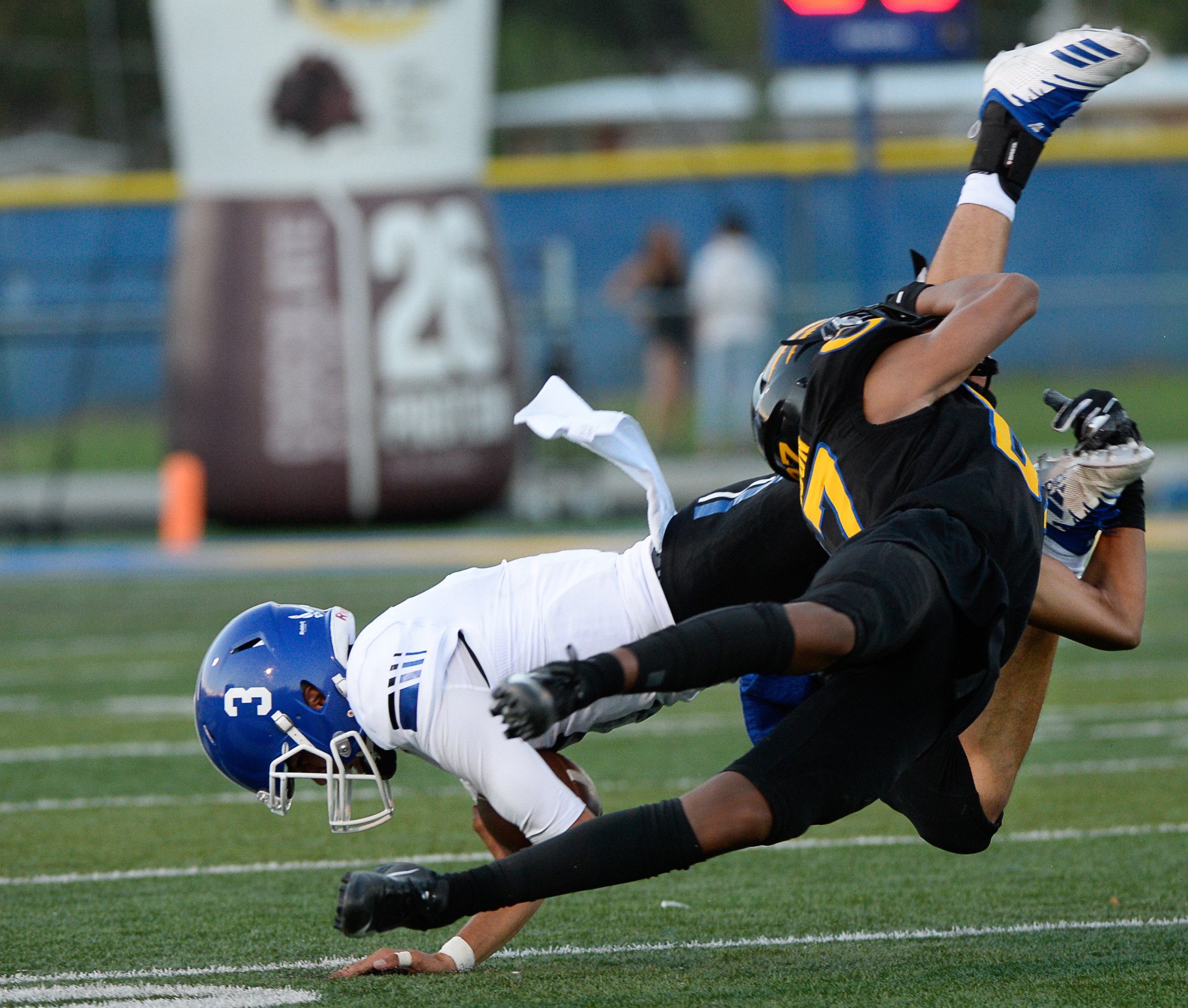 (Francisco Kjolseth | The Salt Lake Tribune) Bingham's Peyton Jones is upended by Orem's Jakob Robinson during the first half of the game in Orem, Thursday, Aug. 16, 2018.