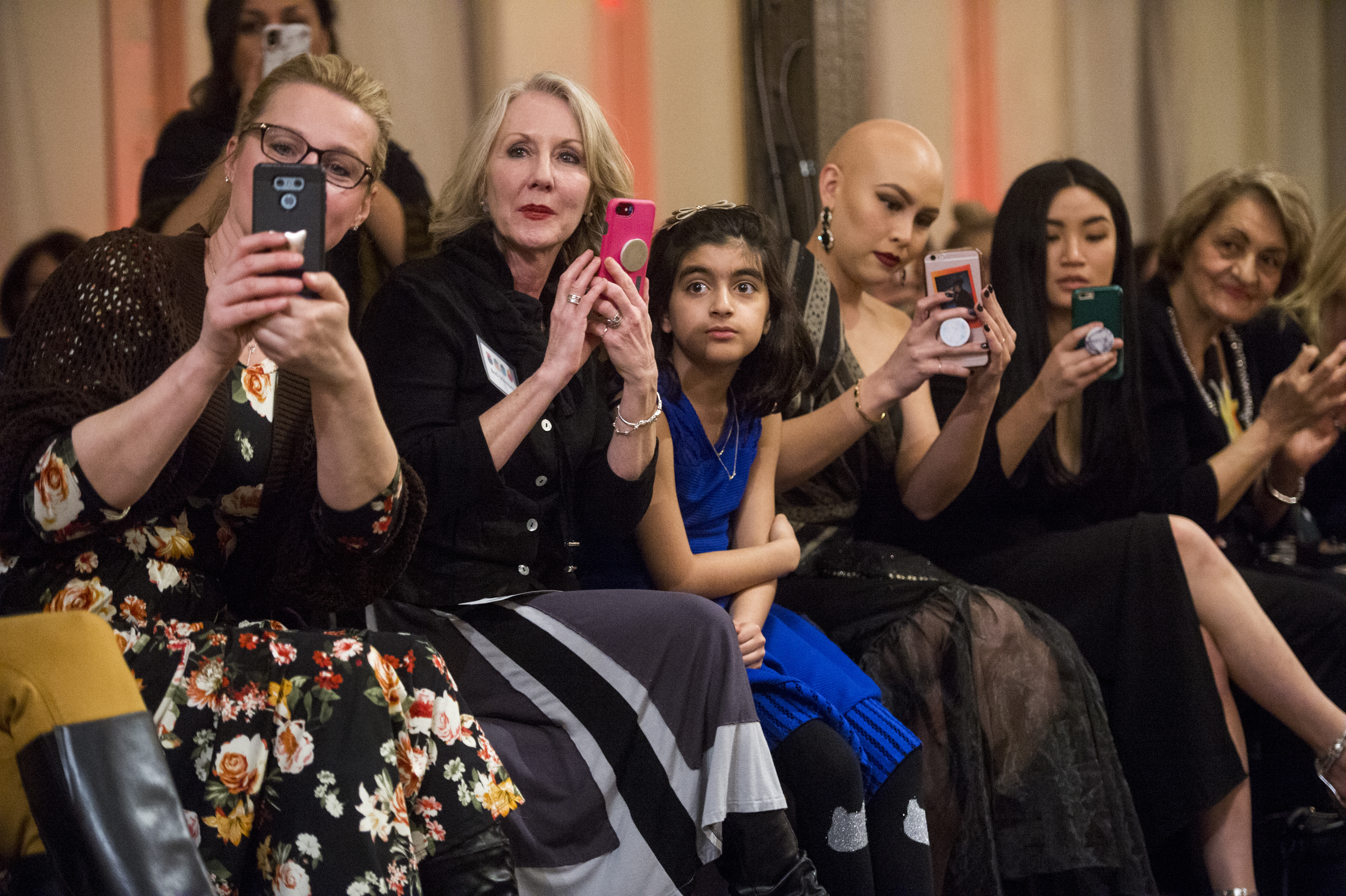(Rick Egan | The Salt Lake Tribune) Guests watch teh models come down the runway, at the 8th Annual Women of the World Fashion Show. The fashion show fund is raiser for the non-profit that seeks to help refugees settle in a new culture. Wednesday, March 7, 2018. 