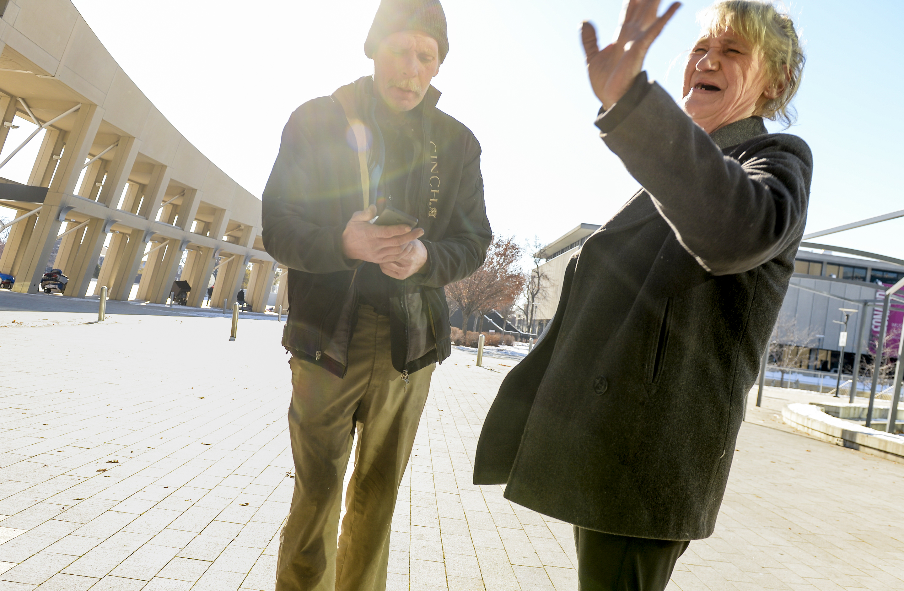 (Leah Hogsten | The Salt Lake Tribune) Katherine Barrett, 54, greets an aquaintance outside the Salt Lake Library. "We're starting to have hope again," said Katherine Barrett, 54, of finding housing for her and her husband Ron Barrett, 55, center, who have been living on the streets of Salt Lake City for the past two years. The Barretts are trying to find housing through a Shelter Plus Care housing voucher through the Salt Lake City Housing Authority. The couple says they refuse to stay in the state's largest homeless shelter, The Road Home on Rio Grande Street, because of past threats of violence from other residents.