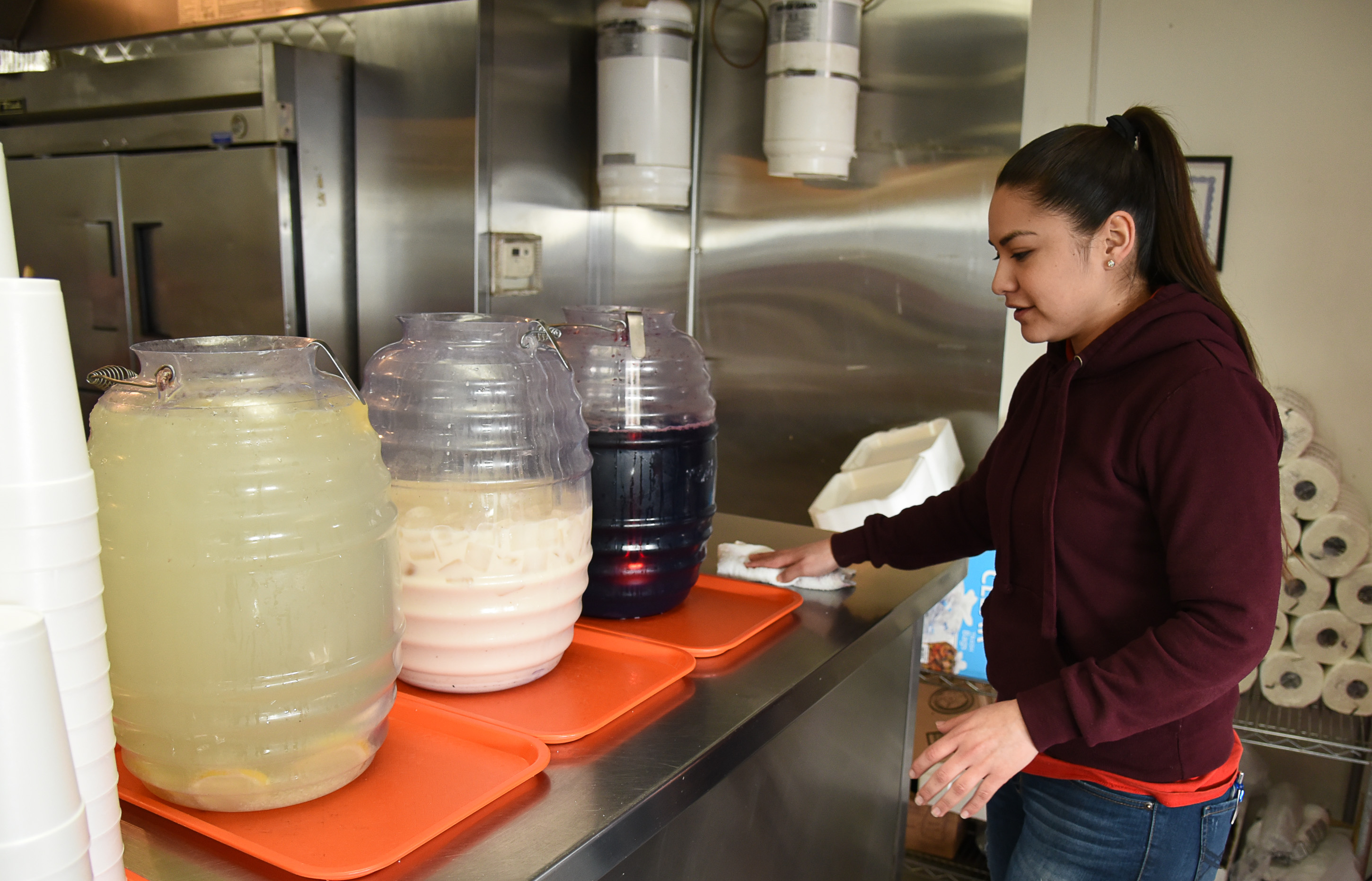 (Francisco Kjolseth | The Salt Lake Tribune) Sandy Vasquez offers limeade, horchata and jamaica drinks at Tacos Mi Caramelo, a late-night taqueria that is open until 2 a.m. most nights and 24-hours a day on Friday and Saturday in West Valley City.
