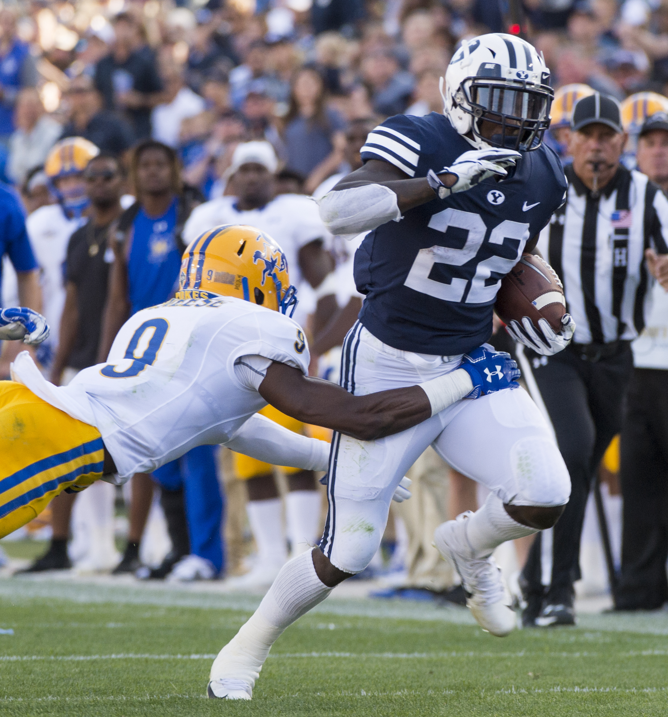 (Rick Egan | The Salt Lake Tribune) Brigham Young Cougars running back Squally Canada (22) gets past McNeese State Cowboys defensive back Trent Jackson (9), in football action Brigham Young Cougars vs McNeese State Cowboys at Lavell Edwards Stadium, Saturday, Sept. 22, 2018. 