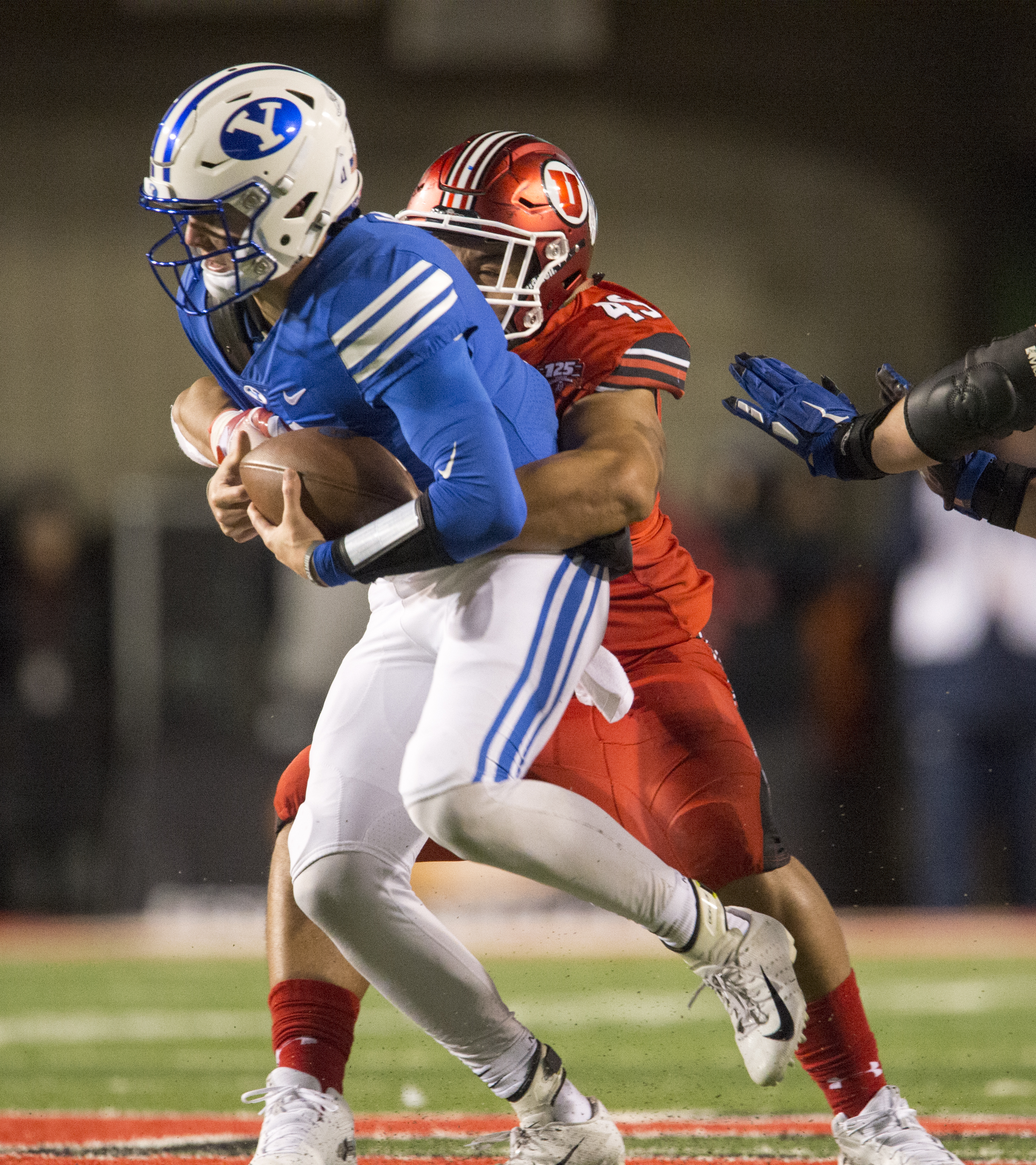 (Rick Egan | The Salt Lake Tribune) Utah Utes defensive tackle Pita Tonga (49) wraps up Brigham Young Cougars quarterback Zach Wilson (11) for a sack, in football action between the Brigham Young Cougars and the Utah Utes, at Rice-Eccles Stadium, Saturday, November 24, 2018. 