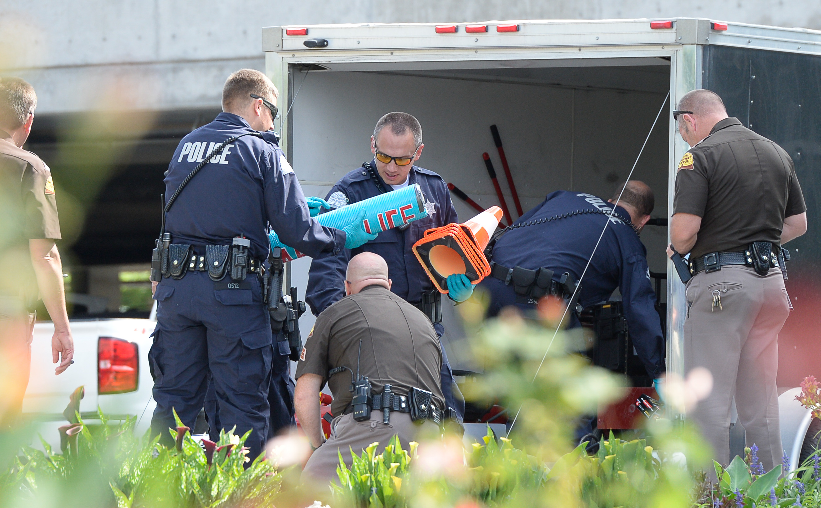 (Francisco Kjolseth | The Salt Lake Tribune) Police gather evidence, including arm lock tubes with the words "ABOLISH ICE" after activists staged a protest against a private prison company with contracts to hold undocumented immigrants on Thursday, July 12, 2018, at the headquarters of Management and Training Corporation in Centerville.