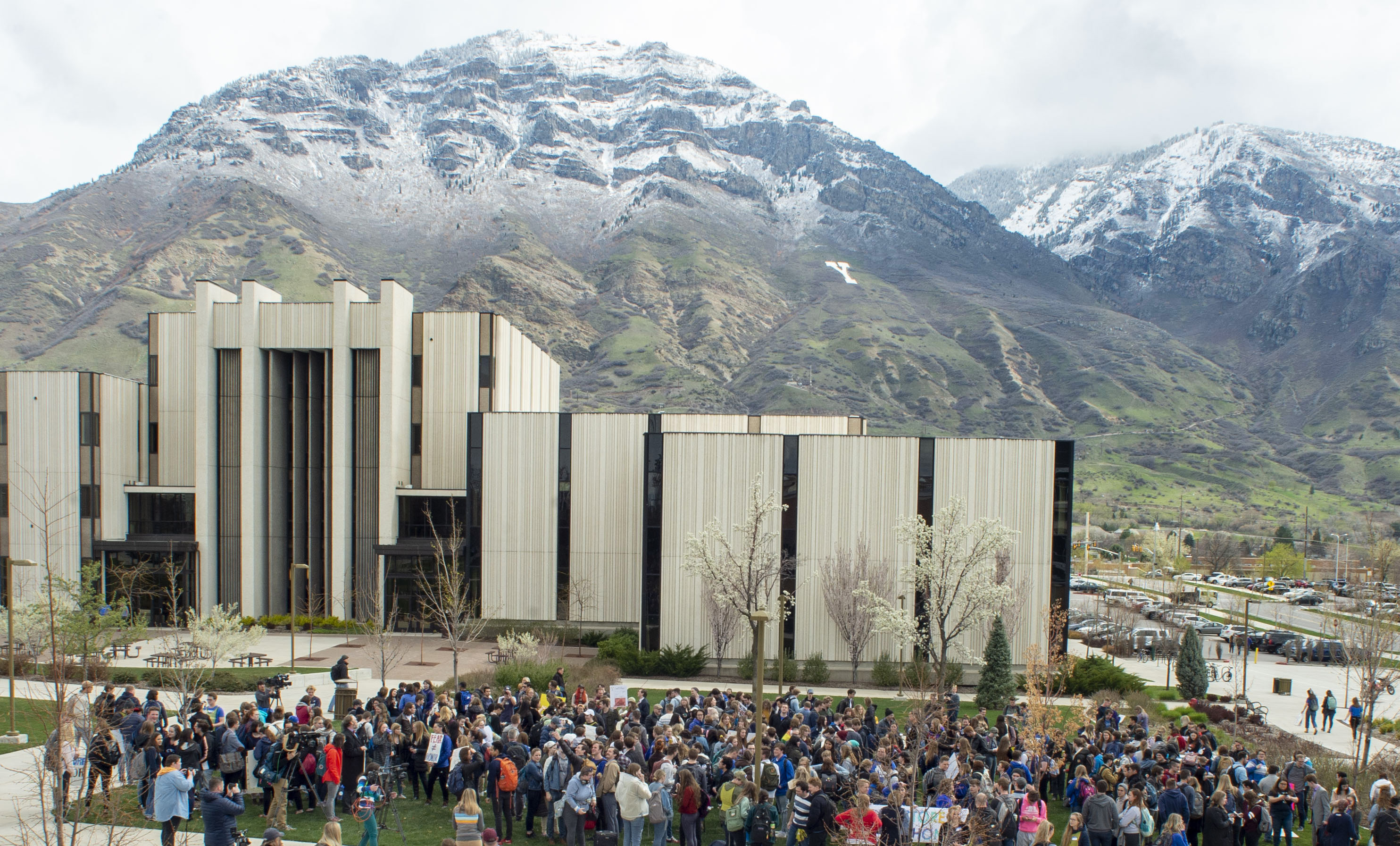 Hundreds of students gather on the campus of Brigham Young University, for a rally to oppose how the school's Honor Code Office investigates and disciplines students, Friday, April 12, 2019, in Provo, Utah. A strict set of rules at Mormon-owned Brigham Young University banning things commonplace at many campuses such as drinking, premarital sex, beards and piercings is under new scrutiny — this time from students who want their university to be more compassionate with the punishments for violators. (Rick Egan/The Salt Lake Tribune via AP)