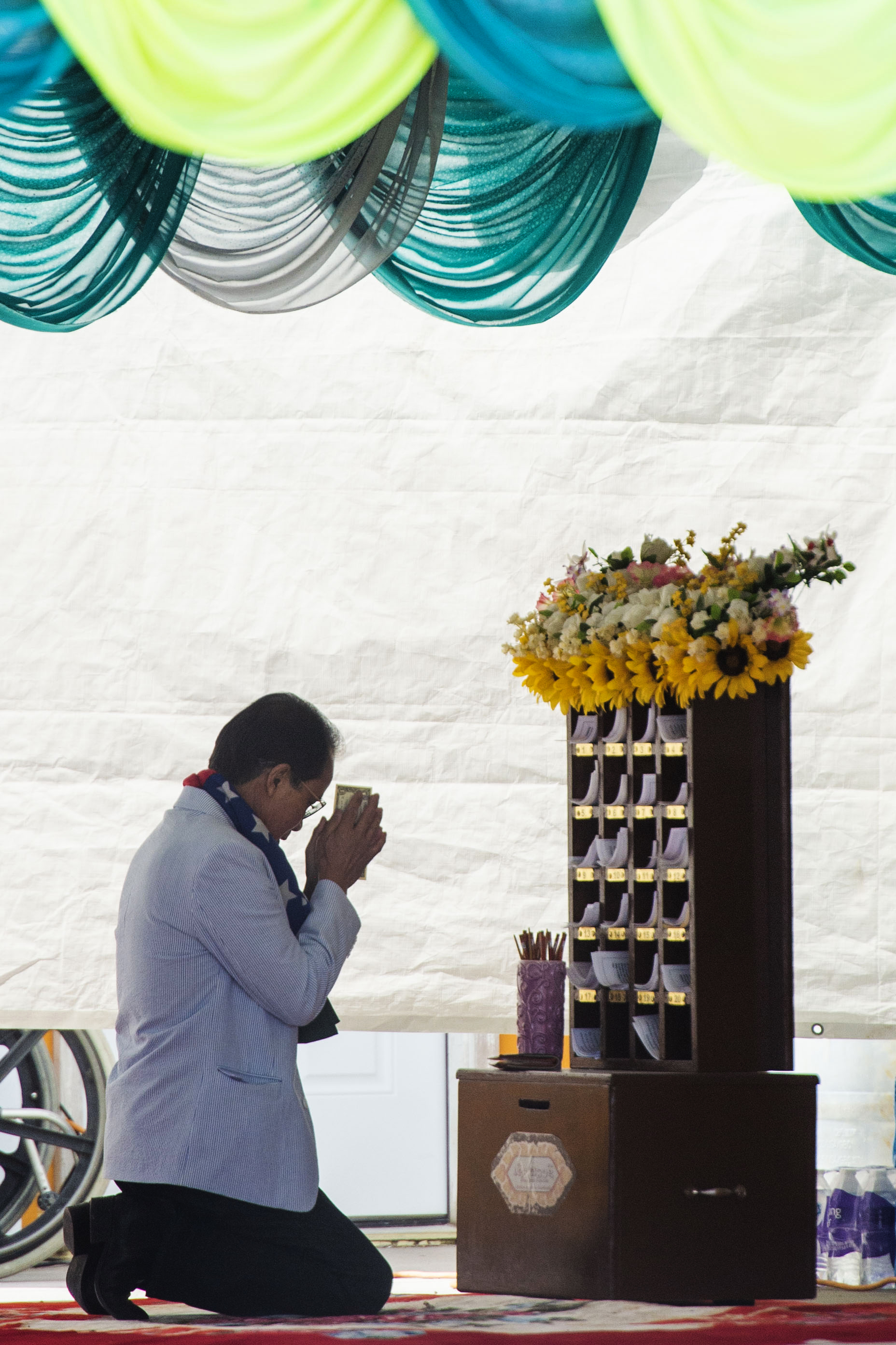 (Rick Egan | The Salt Lake Tribune) A man worships at the Wat Lao Salt Lake Buddharam Utah, New Year Celebration, in West Valley City, Sunday, April 28, 2019. 