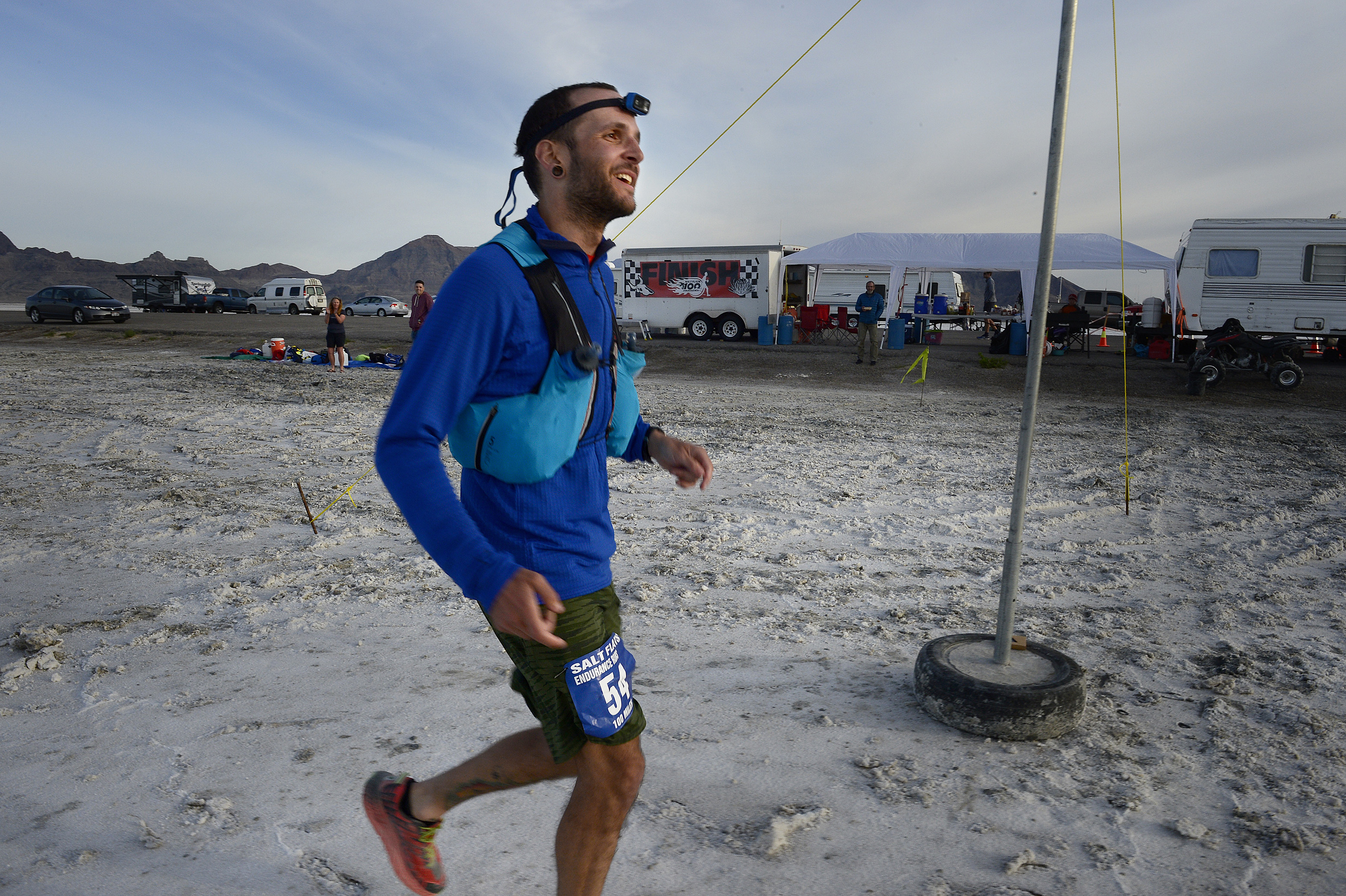 (Scott Sommerdorf | The Salt Lake Tribune) Alex Doolan smiles as he crosses the finish line at the Salt Flats 100 Endurance Run, Saturday, May 5, 2018. Doolan finished in 8th place. 