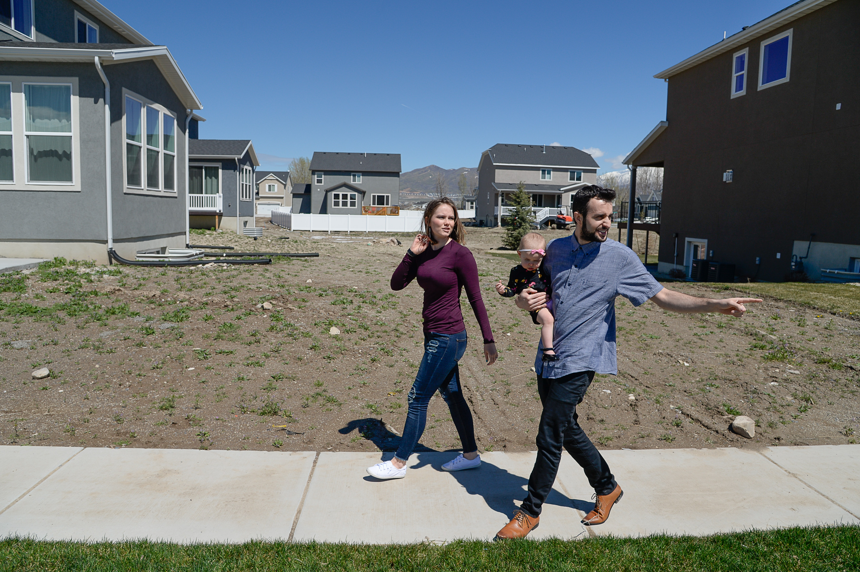 (Francisco Kjolseth | The Salt Lake Tribune) Ember and Jeremy Ulrich take their daughter Jemma, 1, for a walk around their newly developed neighborhood in Lehi after moving there from Pleasant Grove last October. Along with some friends who were also looking to get more house for their money and ended up moving in next door, Jeremy wanted to be closer to his job at Adobe in Lehi.
