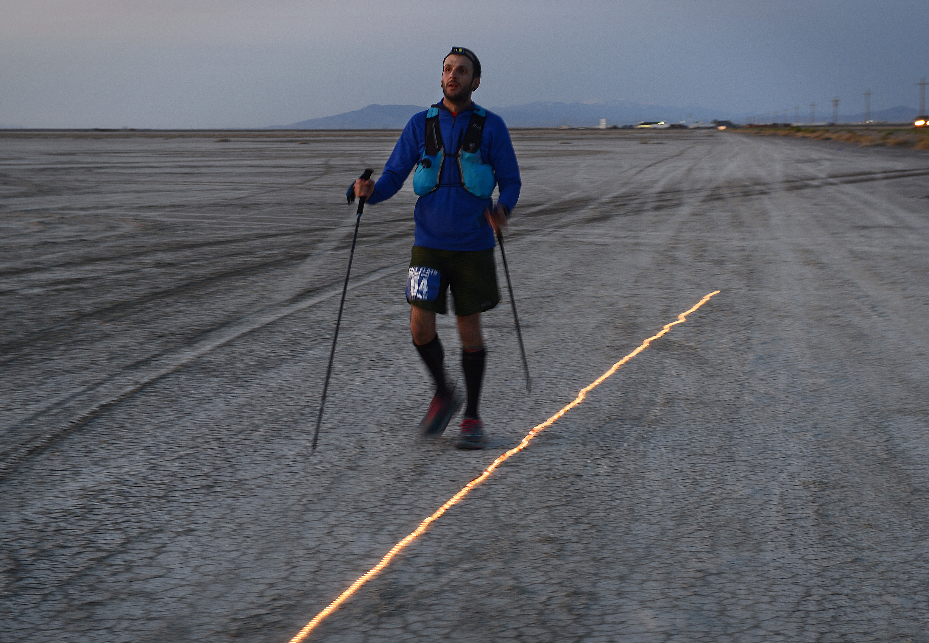 (Scott Sommerdorf | The Salt Lake Tribune) Alex Doolan makes his way to Aid Station 14 - the last checkpoint before the finish line at the Salt Flats 100 Endurance Run, Saturday, May 5, 2018. 