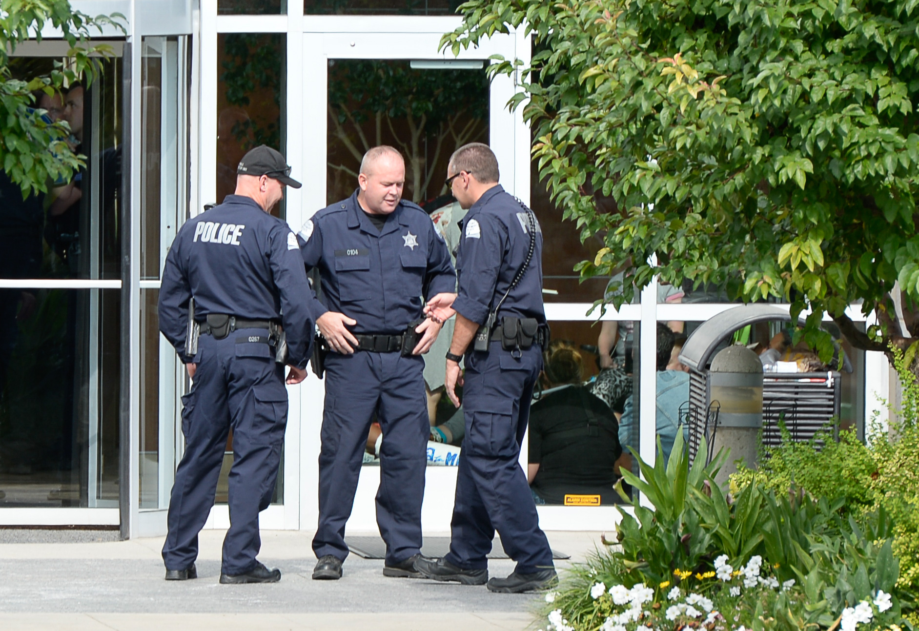 (Francisco Kjolseth | The Salt Lake Tribune) Police gather outside where activists stage a protest against a private prison company with contracts to hold undocumented immigrants on Thursday, July 12, 2018, after locking themselves in the lobby at the headquarters of Management and Training Corporation in Centerville.