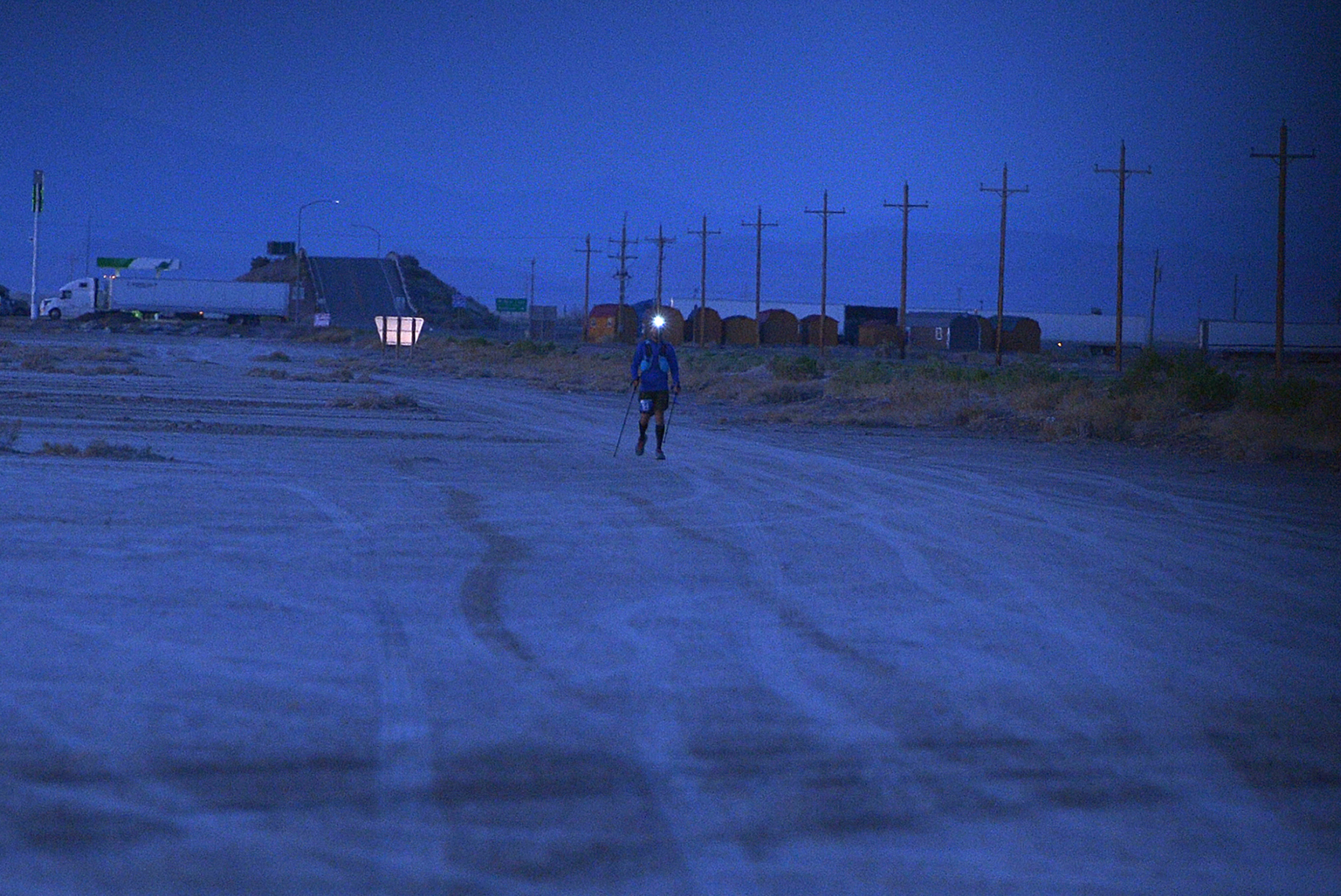 (Scott Sommerdorf | The Salt Lake Tribune) Eighth place finisher Alex Doolan with his headlamp lit, approaches Aid Station 14 at the Salt Flats 100 Endurance Run, Saturday, May 5, 2018. 