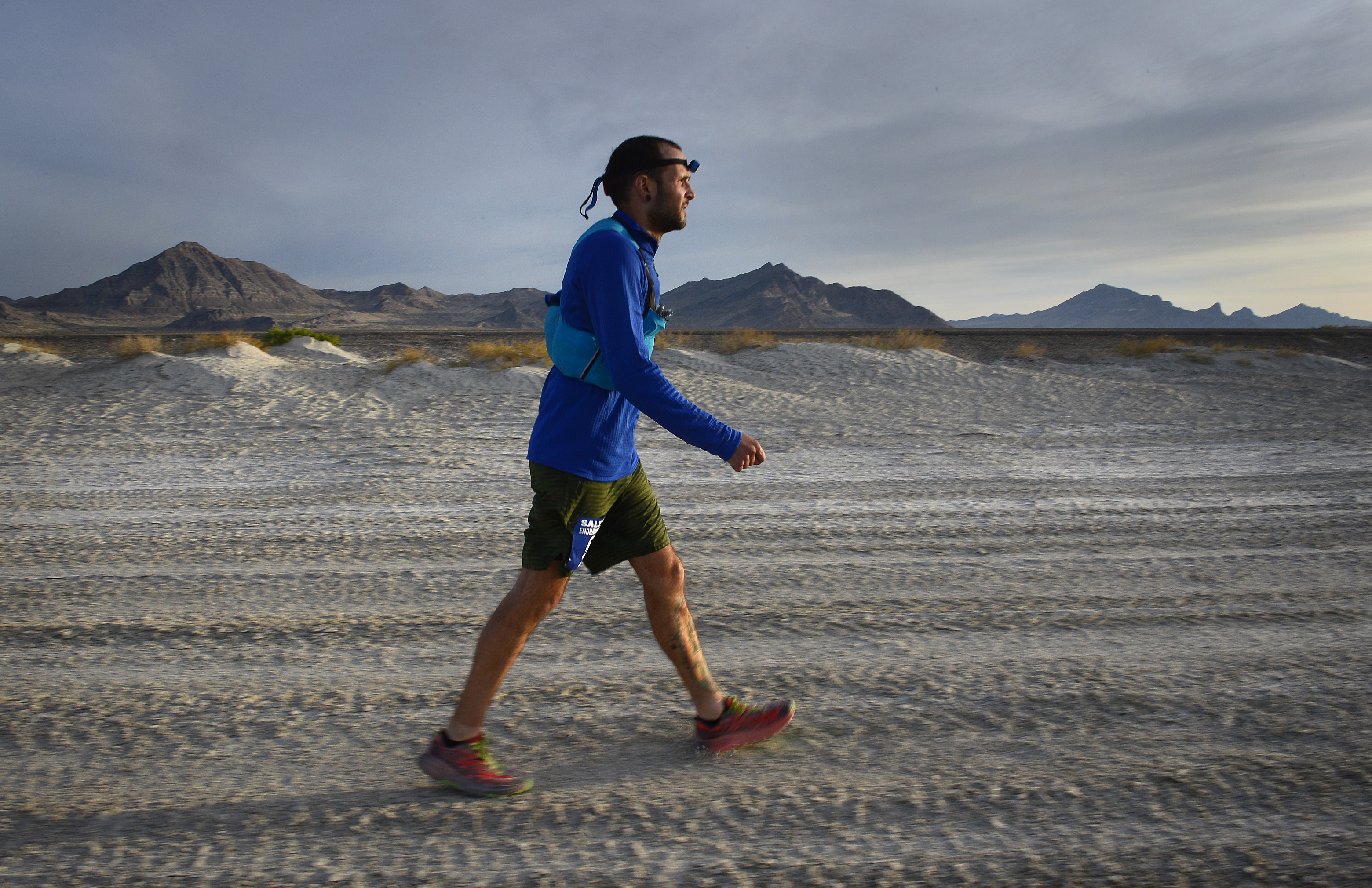 (Scott Sommerdorf | The Salt Lake Tribune) Alex Doolan walks the last mile of the Salt Flats 100 Endurance Run, Saturday, May 5, 2018. 