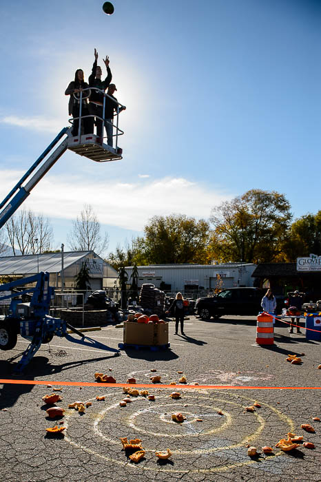 (Trent Nelson | The Salt Lake Tribune) Brian Godfrey launches a watermelon into the air at Glover Nursery in West Jordan on Saturday Nov. 3, 2018. The nursery held its annual pumpkin smash and food drive, dropping pumpkins from a cherry picker and collecting donations for the needy.