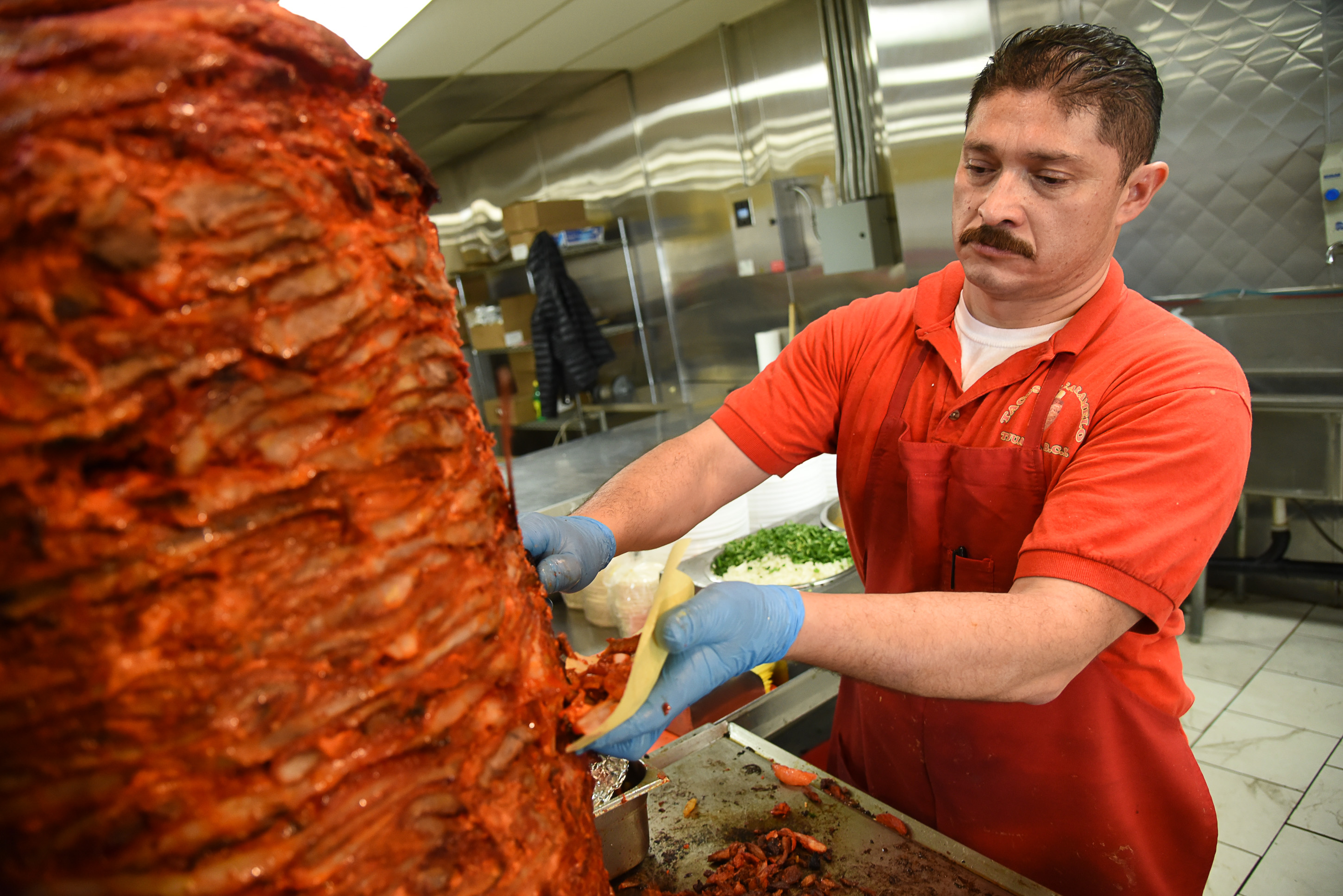 (Francisco Kjolseth | The Salt Lake Tribune) Raul Aispuro assembles tacos al pastor, the most popular offering at Tacos Mi Caramelo, a late-night taqueria that is open until 2 a.m. most nights and 24-hours a day on Friday and Saturday in West Valley City.