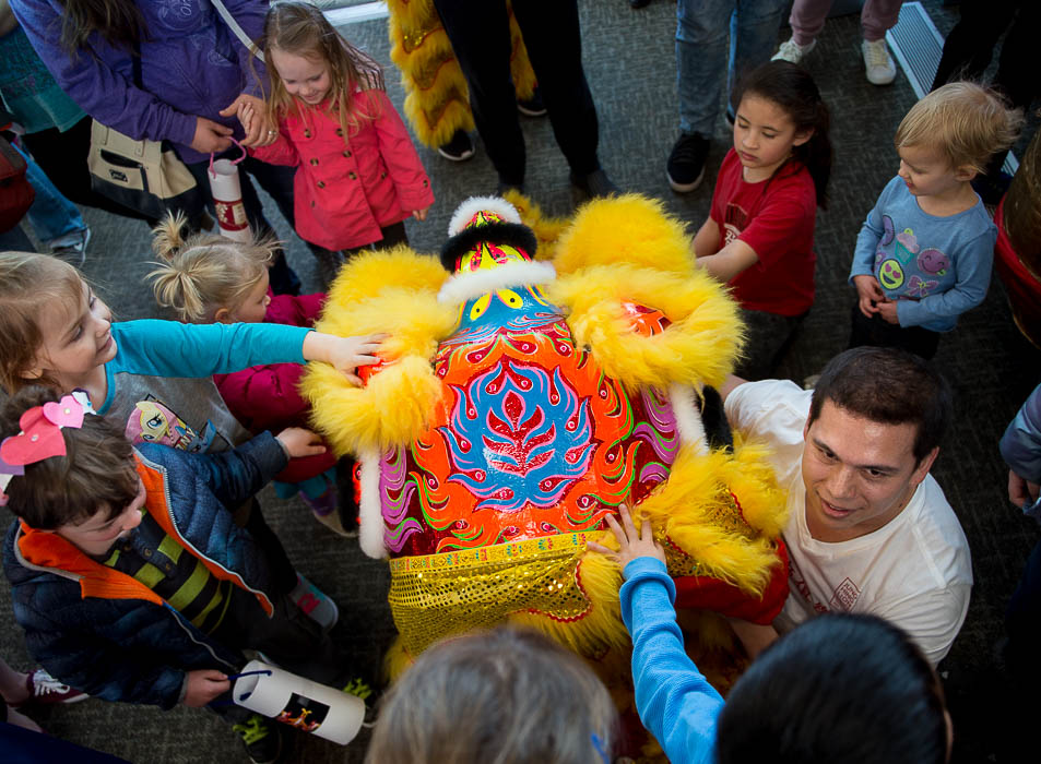 (Trent Nelson | The Salt Lake Tribune) Children swarm around Itzak Lefler and his lion head following a performance by Jung Hing Dragon Dance at the Chinese New Year Celebration at the County Library's Viridian Event Center in West Jordan, Saturday Feb. 17, 2018.