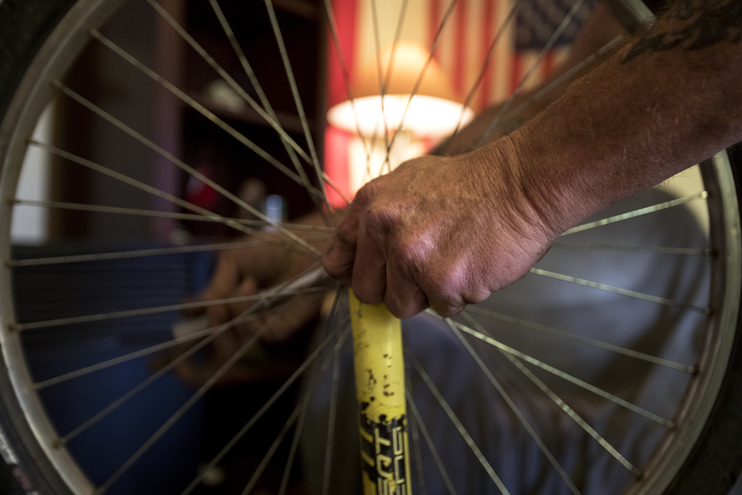 Doug "Boy Scout" Harding replaces the shocks on his bike in the living room of his West Ogden home on Jan. 2, 2018. Two years after moving into stable housing, Harding talked about setting up his own bike repair shop in his unfinished basement. (Benjamin Zack/Standard-Examiner via AP)