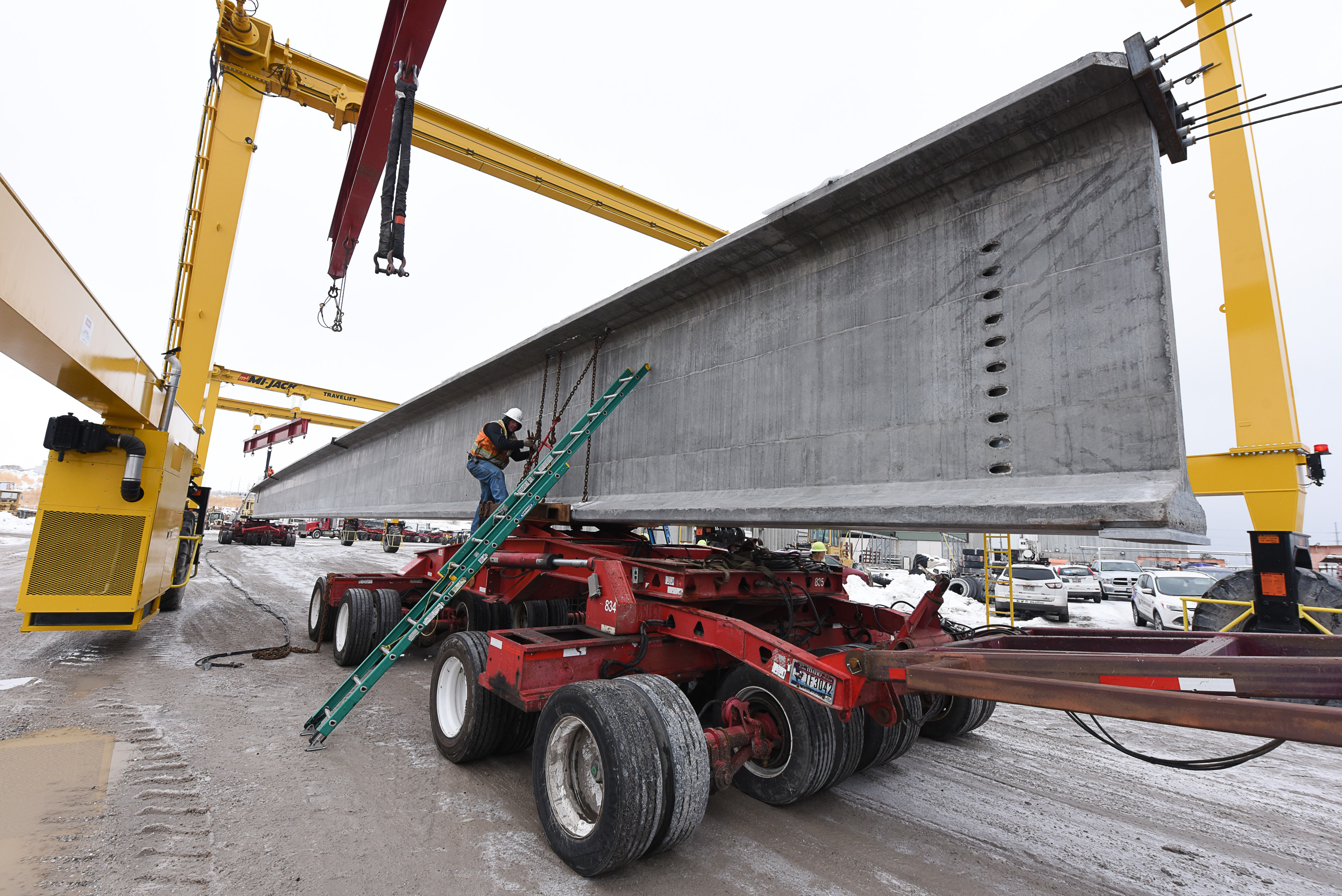 (Francisco Kjolseth | The Salt Lake Tribune) UDOT gets ready to place some of the world's largest-ever bridge beams, and the largest in Utah state history with a span of 203 ft long and just over 8 ft tall, as crews load one on a truck following manufacturing at Forterra Structural Precast in Kearns on Tuesday, Dec. 11, 2018. A total of six beams will be installed in the technology corridor in Lehi later this week.