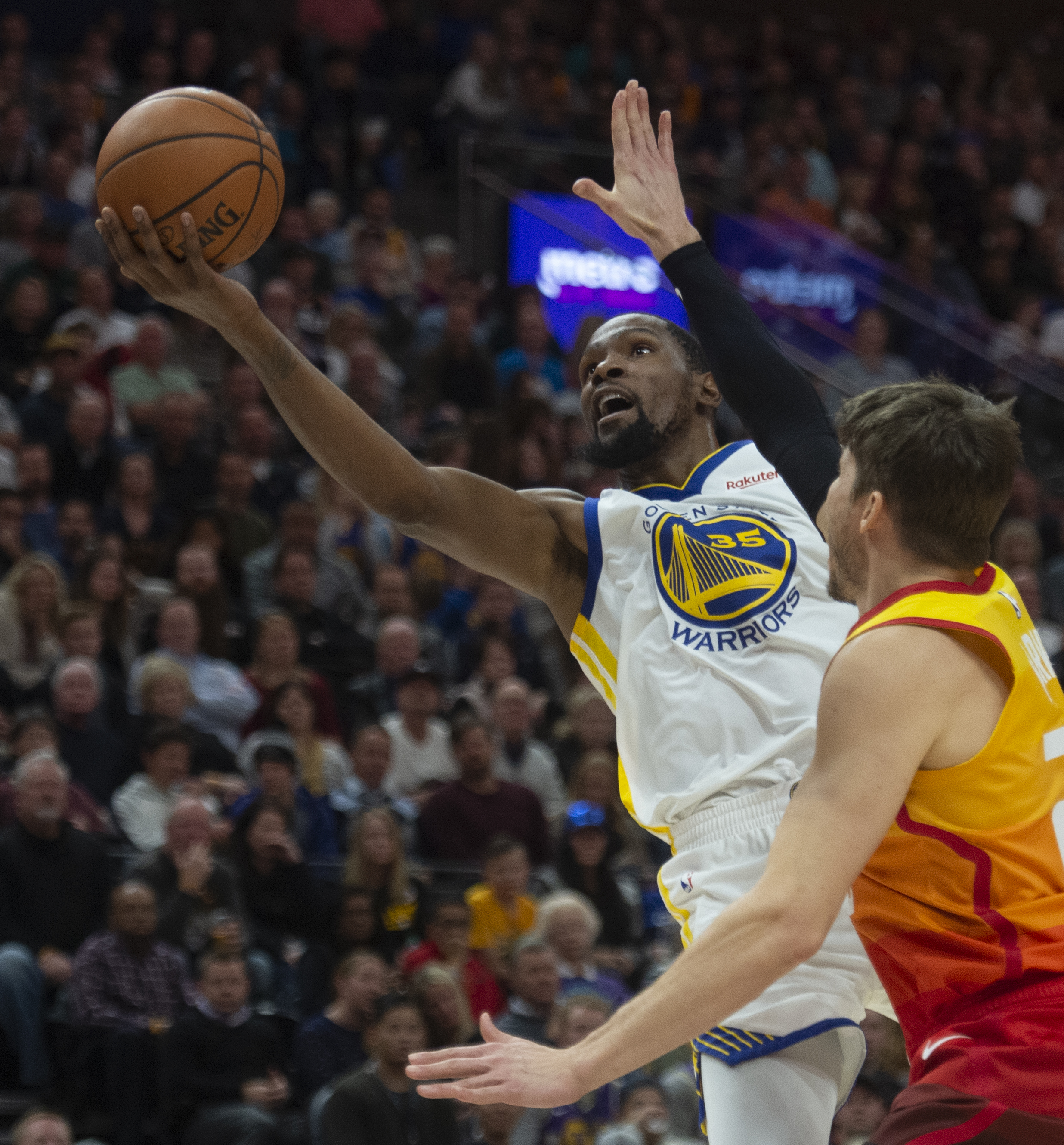 (Rick Egan | The Salt Lake Tribune) Golden State Warriors forward Kevin Durant (35) goes in for a shot as Utah Jazz guard Kyle Korver (26) defends, in NBA action between Utah Jazz and Golden State Warriors, in Salt Lake City, Wednesday, Dec. 19, 2018. 