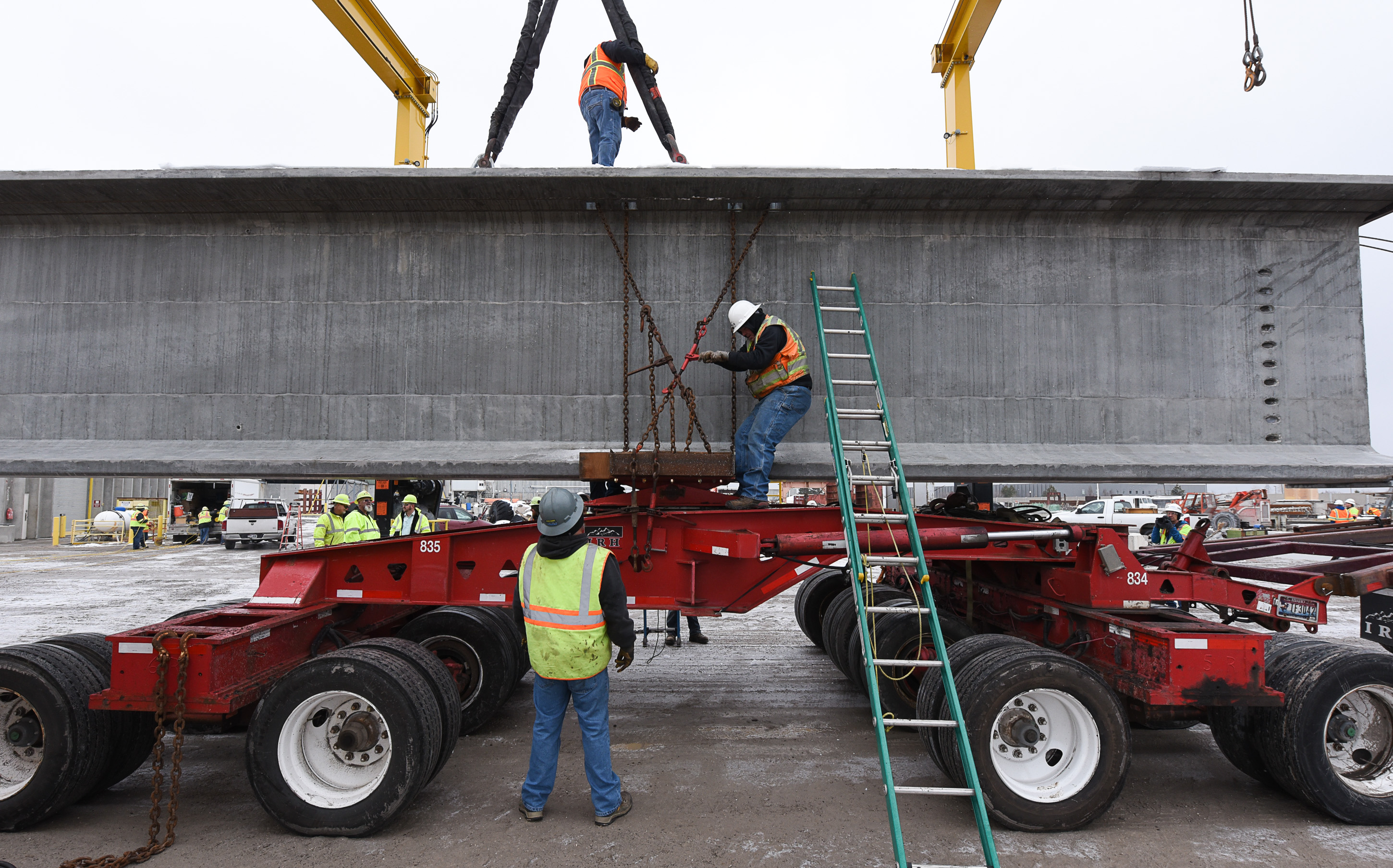 (Francisco Kjolseth | The Salt Lake Tribune) UDOT gets ready to place some of the world's largest-ever bridge beams, and the largest in Utah state history with a span of 203 ft long and just over 8 ft tall, as crews load one on a truck following manufacturing at Forterra Structural Precast in Kearns on Tuesday, Dec. 11, 2018. A total of six beams will be installed in the technology corridor in Lehi later this week.