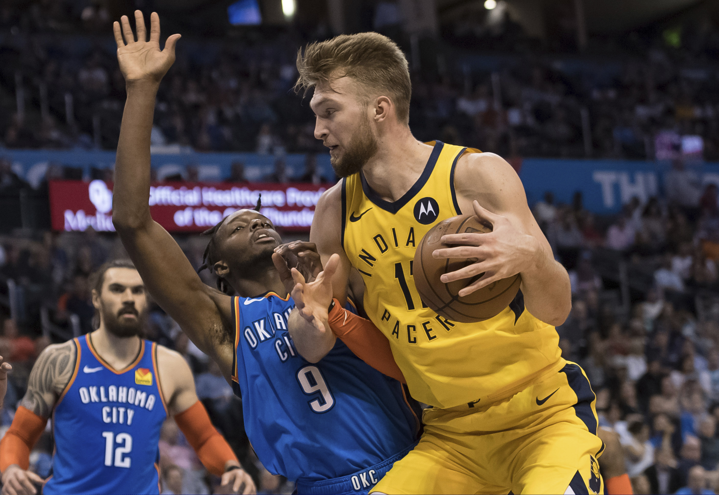 Indiana Pacers forward Domantas Sabonis (11) is defended by Oklahoma City Thunder forward Jerami Grant (9) during the first half of an NBA basketball game Wednesday, March 27, 2019, in Oklahoma City. (AP Photo/Rob Ferguson)