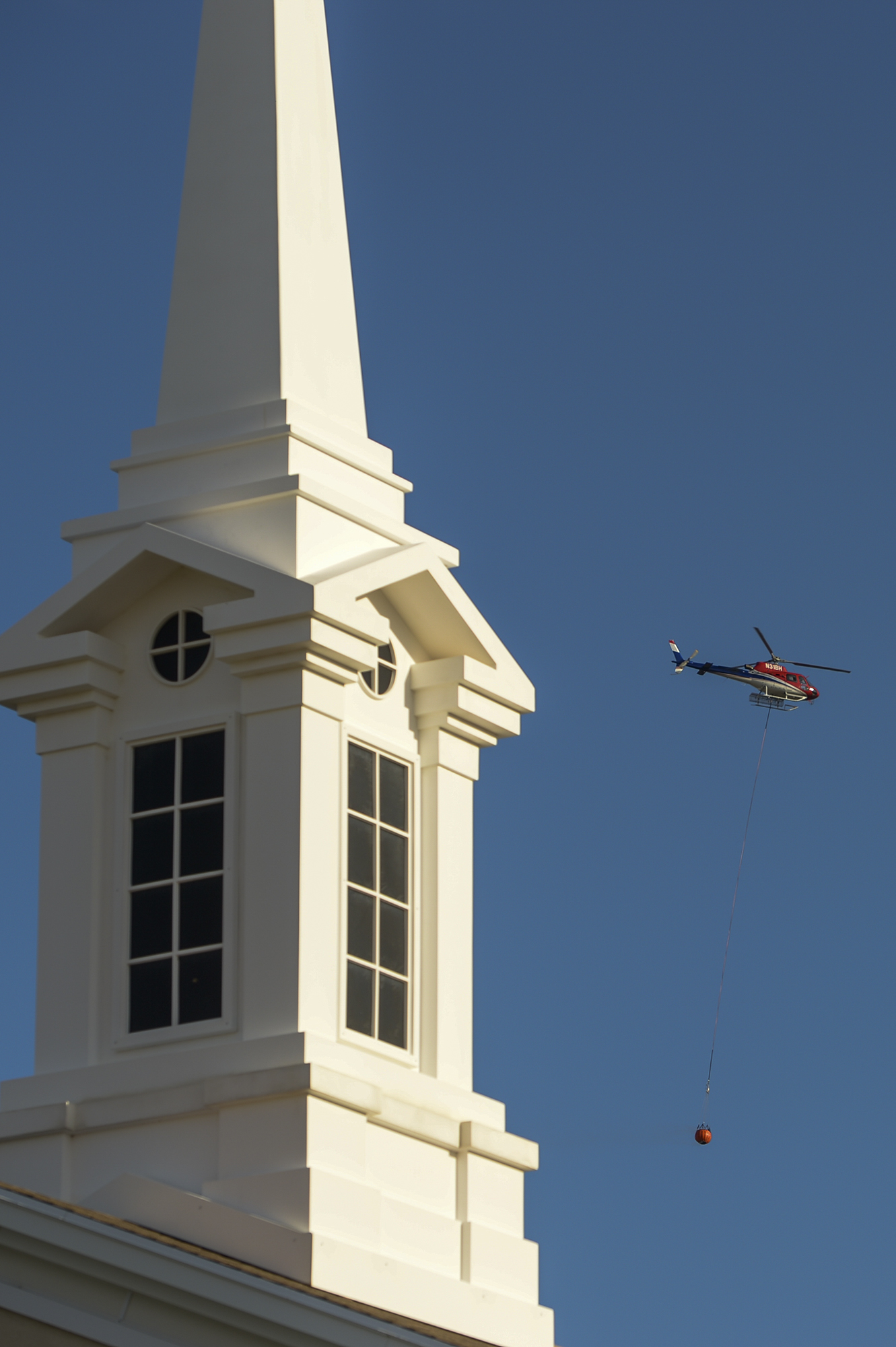 Leah Hogsten | The Salt Lake Tribune A firefighting helicopter refills with water near Herriman Cove pond. A 50-acre wildfire in Rose Canyon was threatened about a half-dozen homes Wednesday, Sept. 12, 2018. A spokesman for Unified Fire said the blaze has already burned a few structures, including outhouses and sheds. Firefighters have evacuated around 20 to 30 homes in two neighborhoods near 15555 S. Rose Canyon Road in Herriman. 
