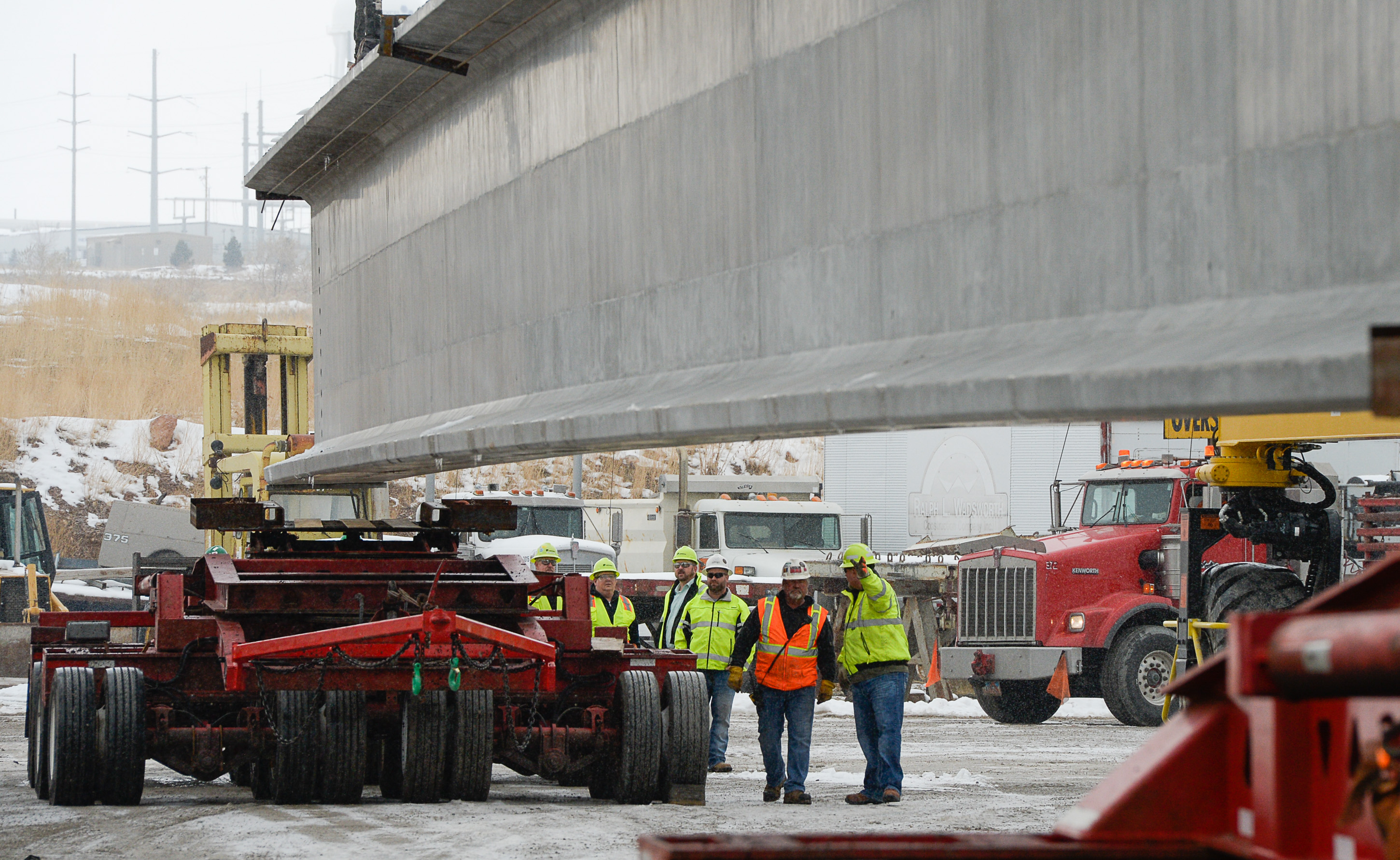 (Francisco Kjolseth | The Salt Lake Tribune) UDOT gets ready to place some of the world's largest-ever bridge beams, and the largest in Utah state history with a span of 203 ft long and just over 8 ft tall, as crews load one on a truck following manufacturing at Forterra Structural Precast in Kearns on Tuesday, Dec. 11, 2018. A total of six beams will be installed in the technology corridor in Lehi later this week.