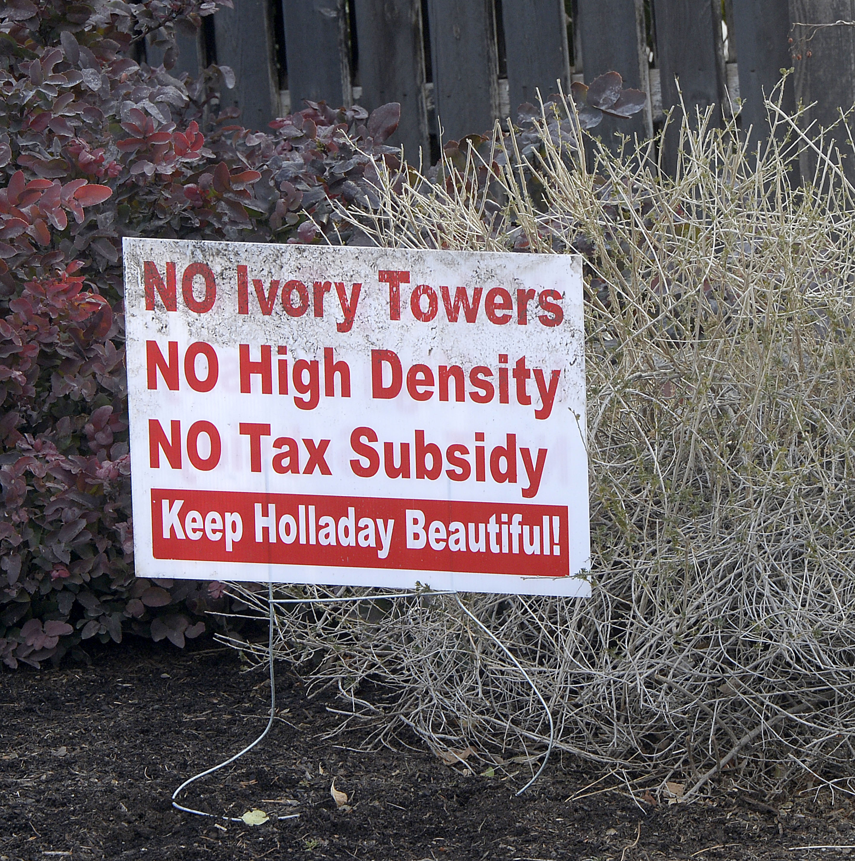 (Al Hartmann | The Salt Lake Tribune) Signs in the front yards of homeowners in the area of the old Cottonwood Mall site near 4800 S. Highland Drive in Holladay on Tuesday, March 13, 2018. 