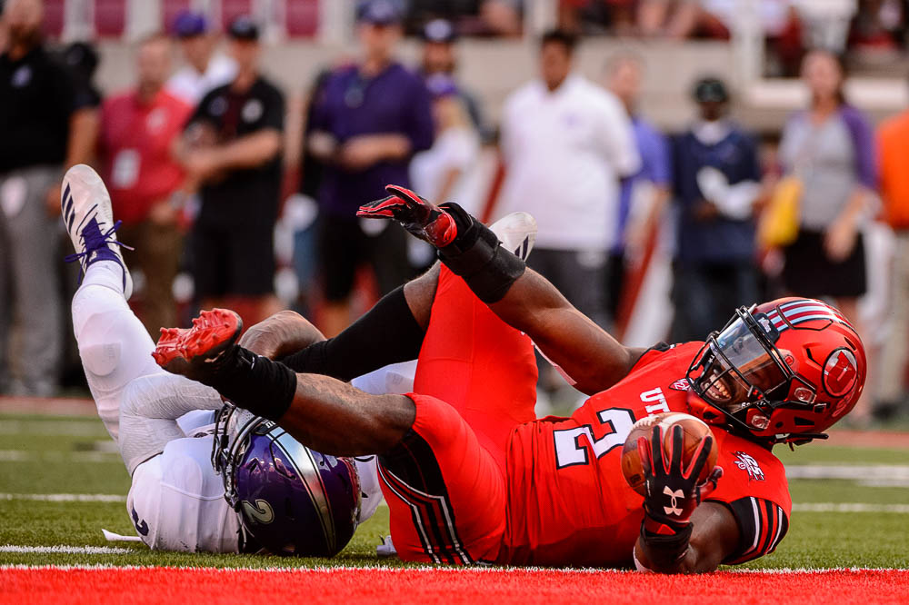 (Trent Nelson | The Salt Lake Tribune) Utah Utes running back Zack Moss (2) is stopped just short of the end zone by Weber State Wildcats safety Jawian Harrison Jr. (2) as the University of Utah Utes host the Weber State Wildcats, Thursday Aug. 30, 2018 at Rice-Eccles Stadium in Salt Lake City.