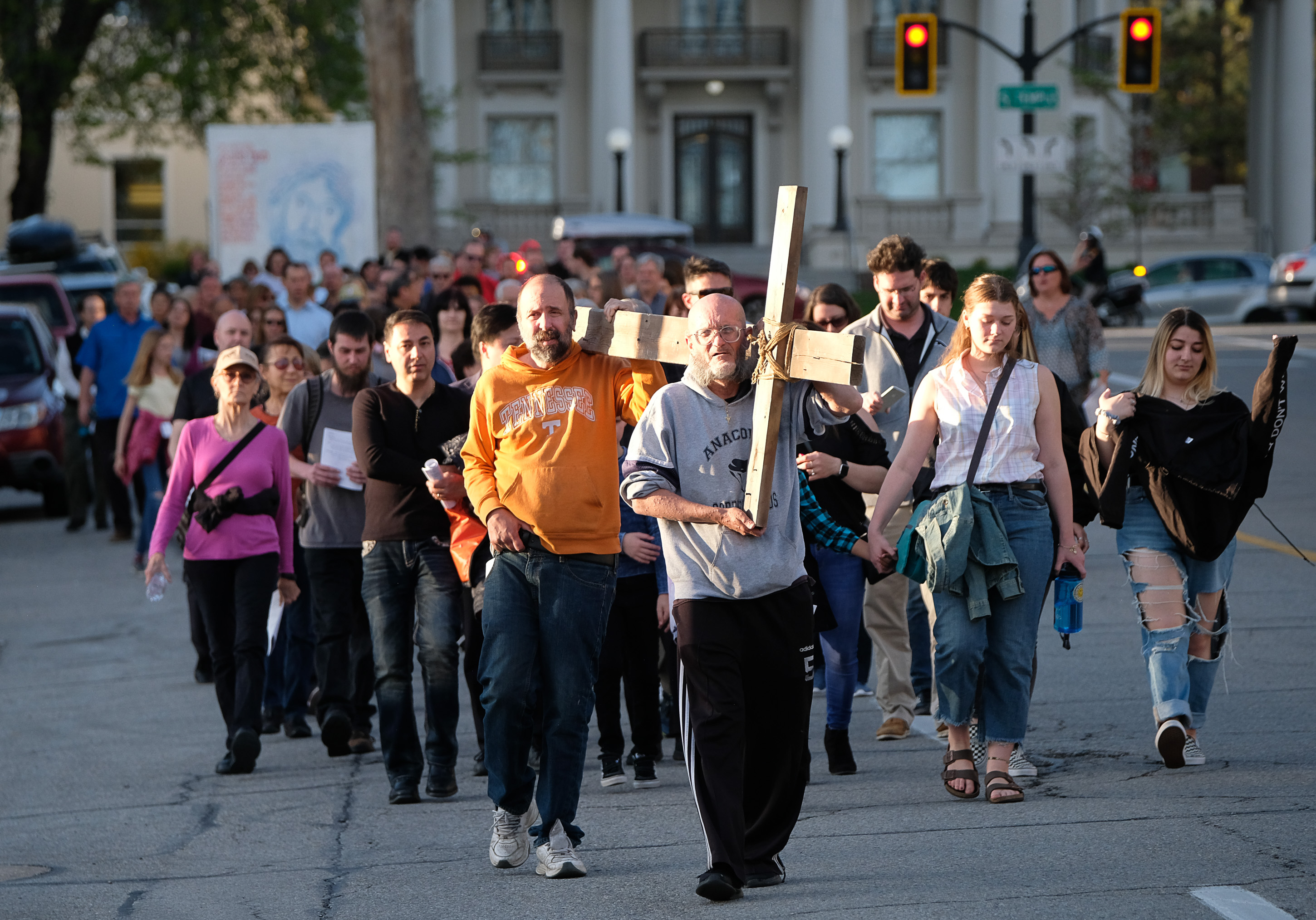 (Francisco Kjolseth | The Salt Lake Tribune) Alex Bury, front, and Kent Kilburn take a turn carrying the cross as christians march through streets of Salt Lake City on Good Friday to symbolically mark Jesus' carrying the cross to his crucifixion beginning at Cathedral of the Madeleine.