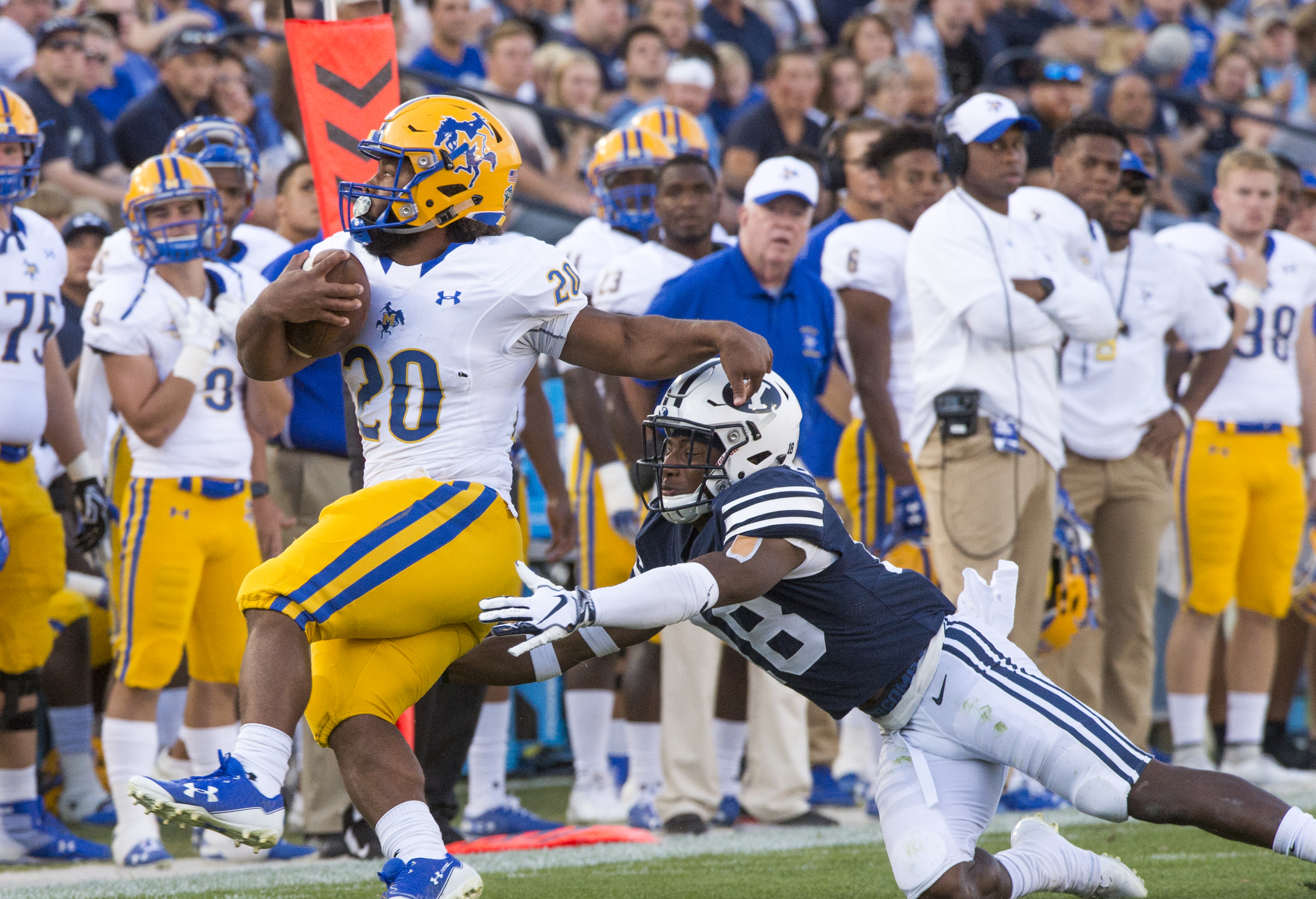 (Rick Egan | The Salt Lake Tribune) Brigham Young Cougars defensive back Michael Shelton (18) brings down McNeese State Cowboys running back Justin Pratt (20), in football action Brigham Young Cougars vs McNeese State Cowboys at Lavell Edwards Stadium, Saturday, Sept. 22, 2018. 