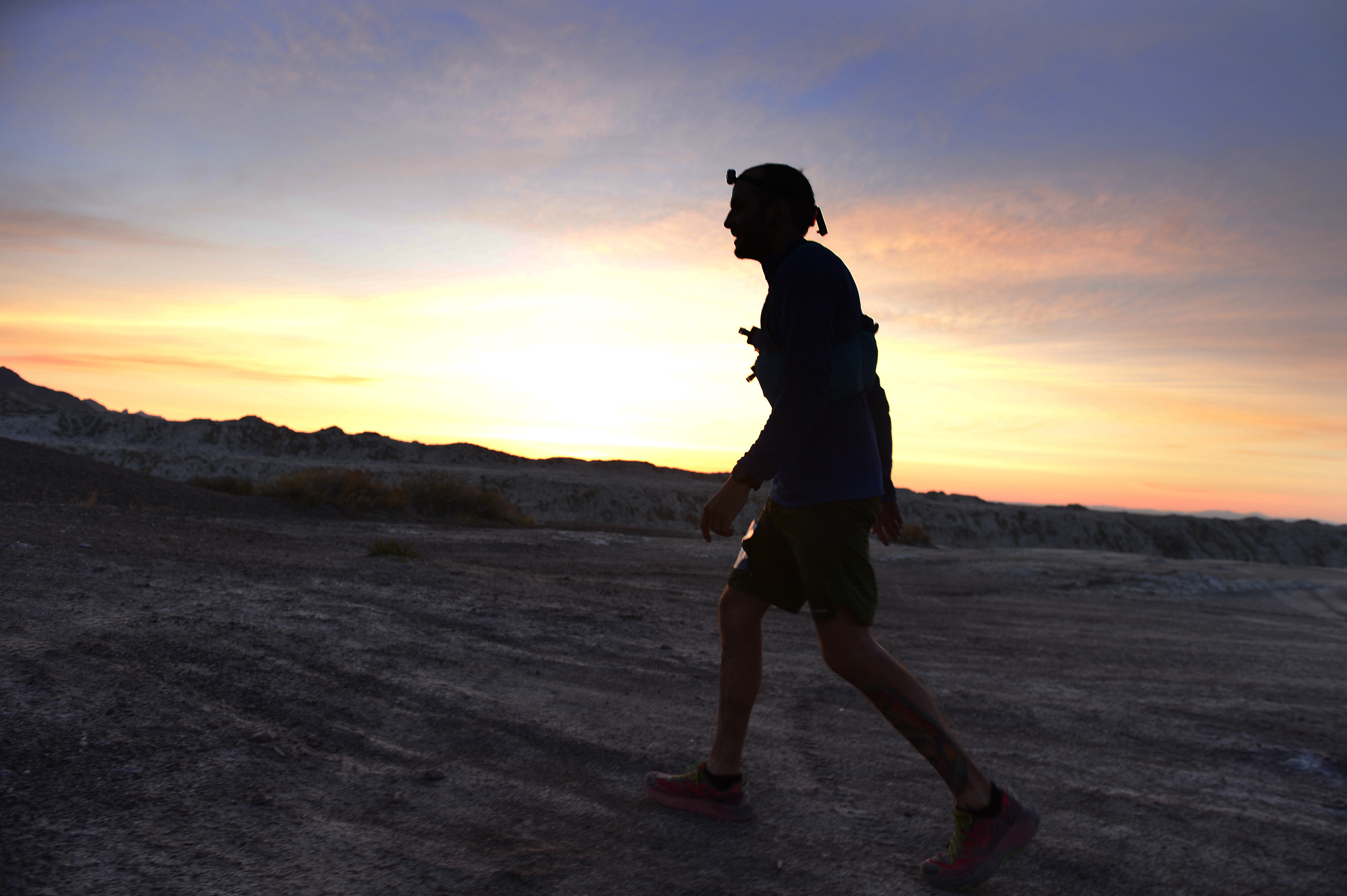 (Scott Sommerdorf | The Salt Lake Tribune) Alex Doolan sets out on the last 3.8 miles as the sun rises at the Salt Flats 100 Endurance Run, Saturday, May 5, 2018. Doolan finished the race in 8th place. 