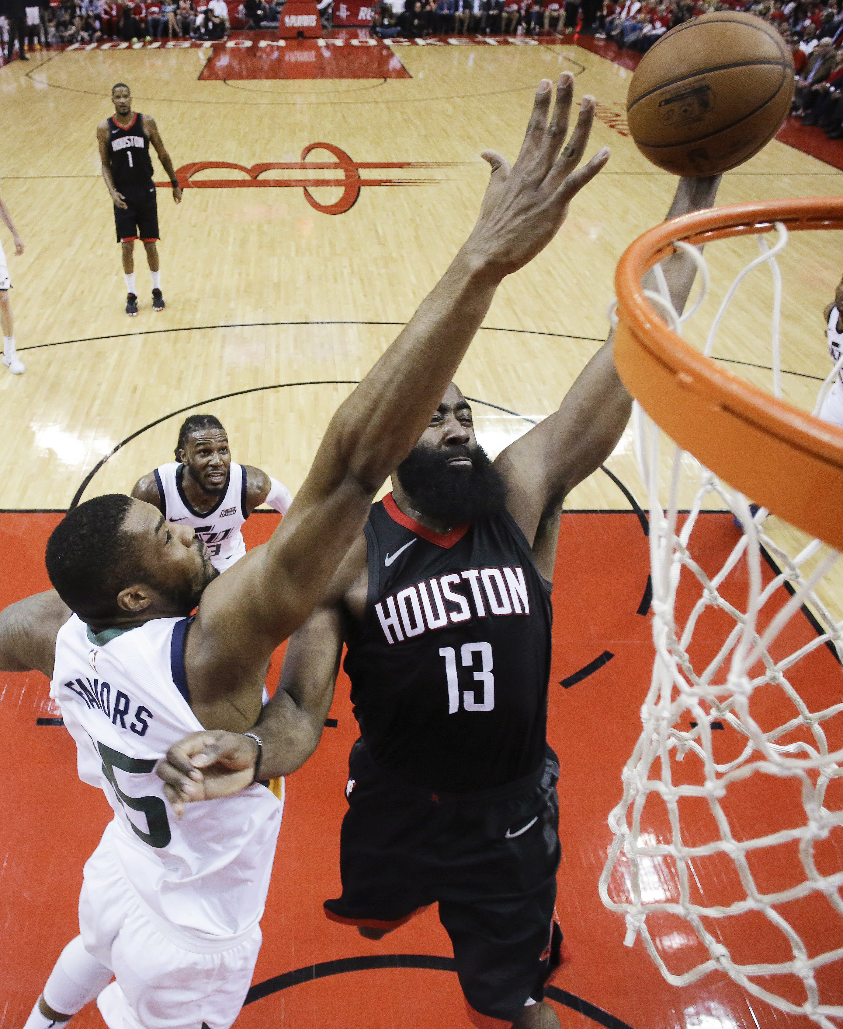 Houston Rockets guard James Harden (13) drives to the basket as Utah Jazz forward Derrick Favors defends during the second half in Game 2 of an NBA basketball second-round playoff series, Wednesday, May 2, 2018, in Houston. (AP Photo/Eric Christian Smith)