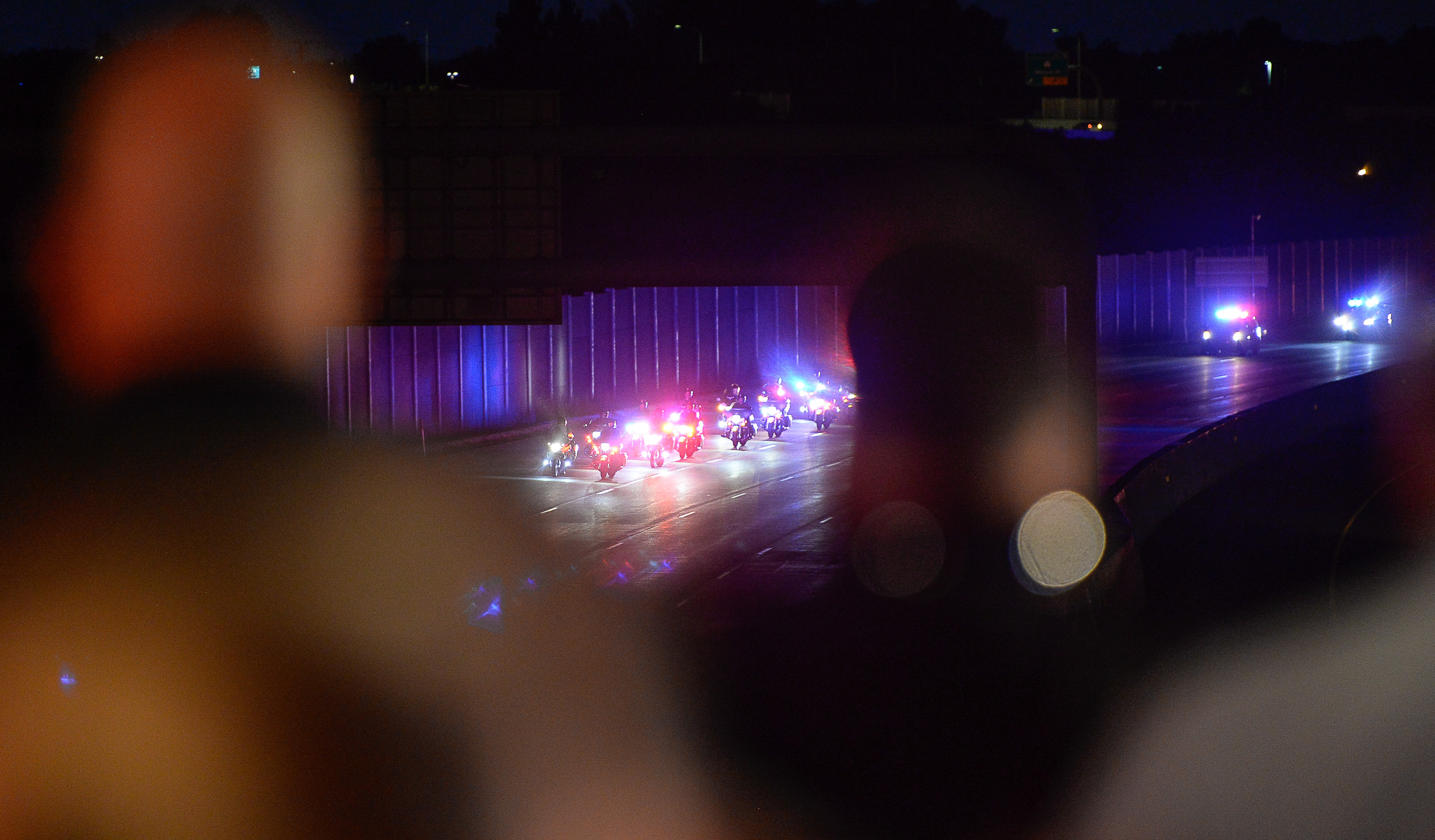 (Francisco Kjolseth | The Salt Lake Tribune) The body of Utah firefighter Matt Burchett, 42, who died fighting a wildfire in California is honored by a firefighter detail along Murray Parkway as his body is returned home, traveling along I-215 after being flown in to the Utah Air National Guard in Salt Lake City on Wed. Aug. 15, 2018. The remains of the Draper battalion chief were transported to Jenkins-Soffe Mortuary in South Jordan.
