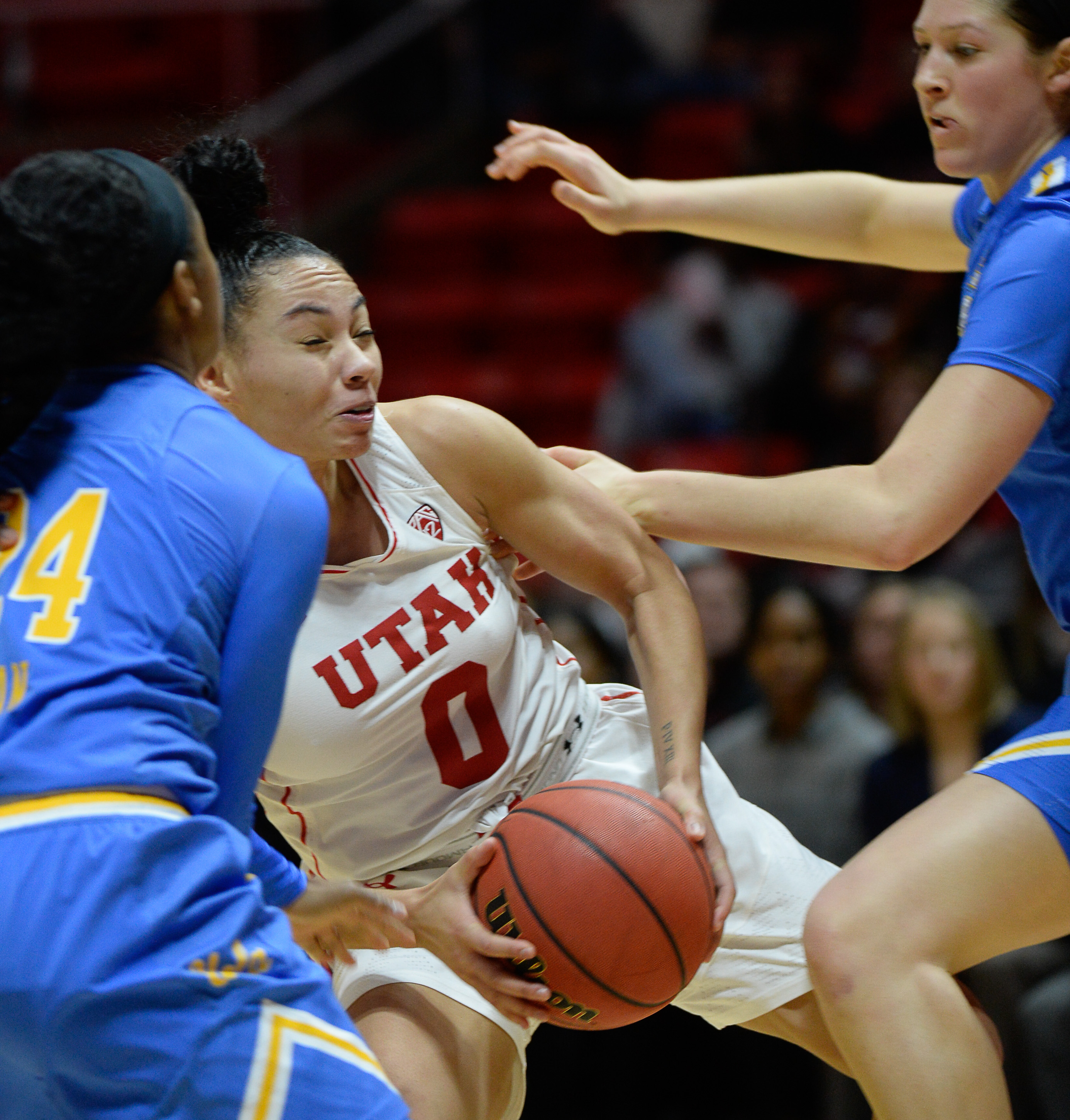 (Francisco Kjolseth | The Salt Lake Tribune) Utah Utes guard Kiana Moore (0) gets roughed up by the UCLA defense at the Jon M. Huntsman Center in Salt Lake City on Sunday, Feb. 10, 2019.
