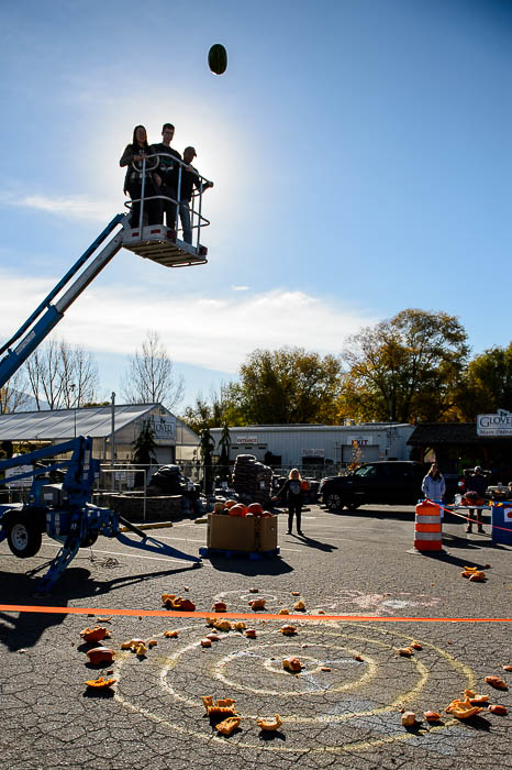 (Trent Nelson | The Salt Lake Tribune) Brian Godfrey launches a watermelon into the air at Glover Nursery in West Jordan on Saturday Nov. 3, 2018. The nursery held its annual pumpkin smash and food drive, dropping pumpkins from a cherry picker and collecting donations for the needy.