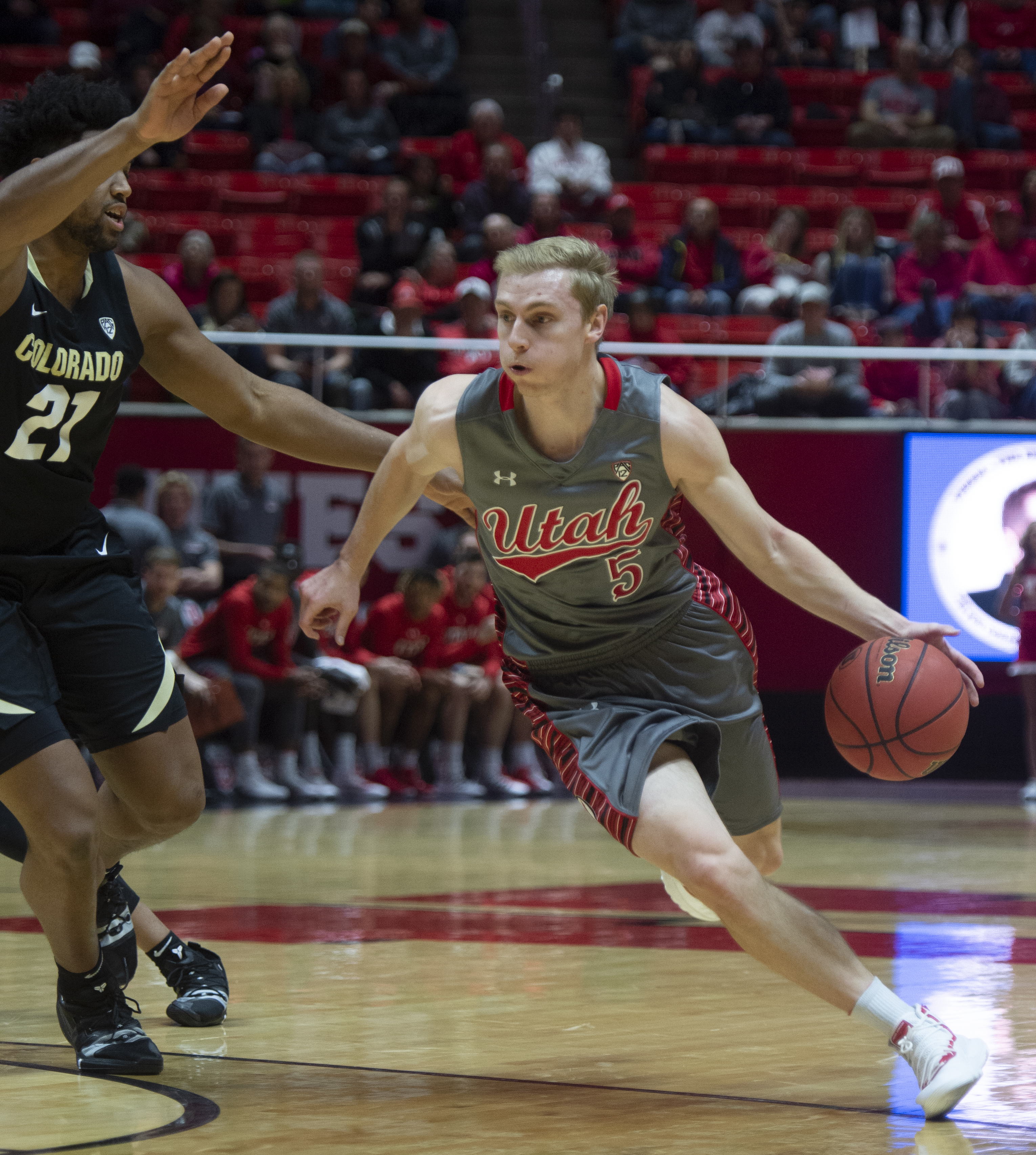 (Rick Egan | The Salt Lake Tribune) Utah Utes guard Parker Van Dyke (5) takes the ball up the middle, as Colorado Buffaloes forward Evan Battey (21) defends, in PAC-12 basketball action between the Utah Utes and the Colorado Buffaloes at the Jon M. Huntsman Center, Sunday, Jan. 20, 2019. 