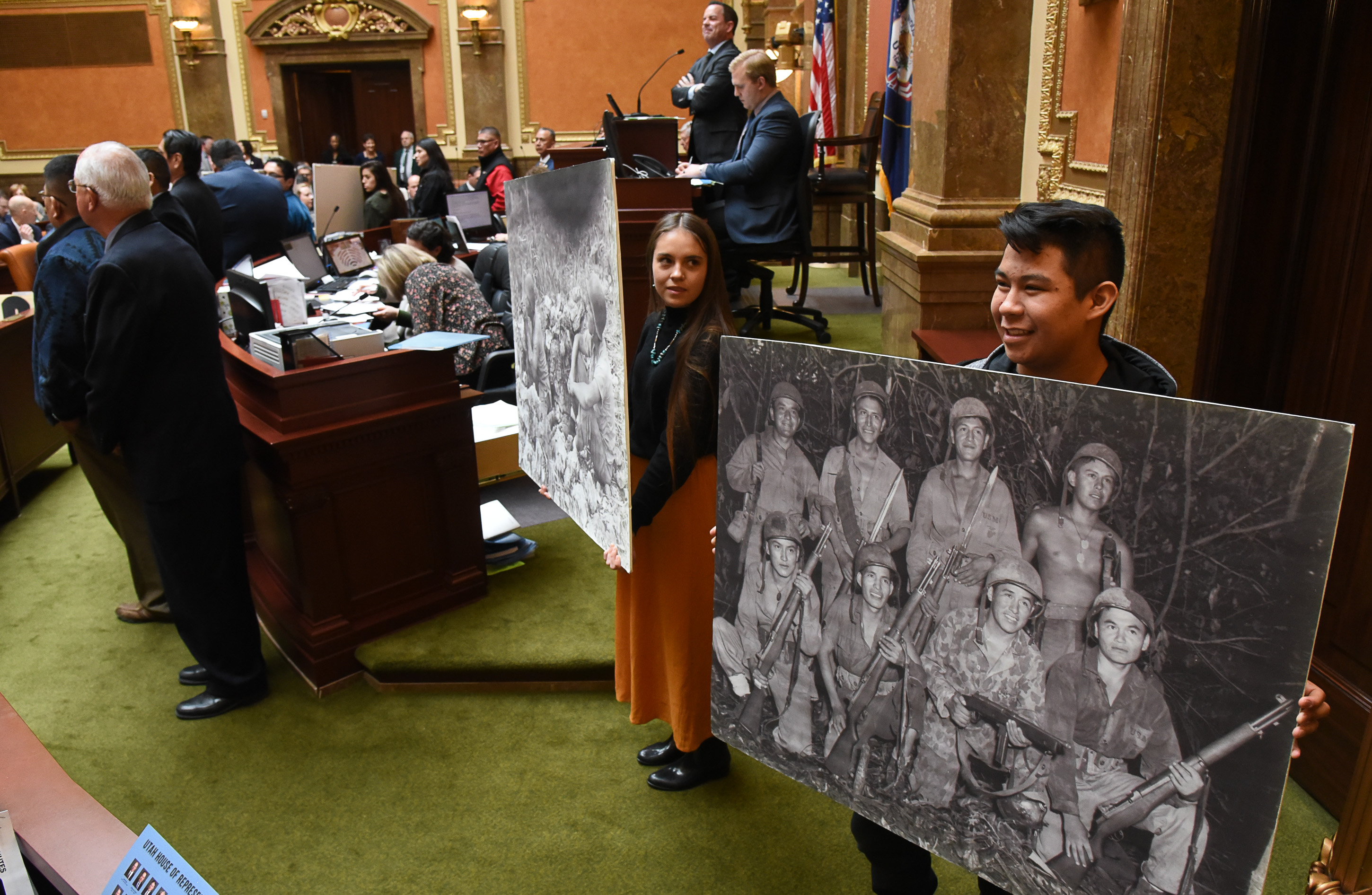 (Francisco Kjolseth | The Salt Lake Tribune) Holding historic photographs of Navajo Code Talkers, Nizhoni Fielding, center, and Andrew Yazzie join Utah lawmakers on Monday as they unanimously passed a resolution honoring the Navajo code talkers and dedicating Aug. 14, 2019, to the World War II service members whose unbreakable code boosted the U.S. Marine Corps in the Pacific Theater.